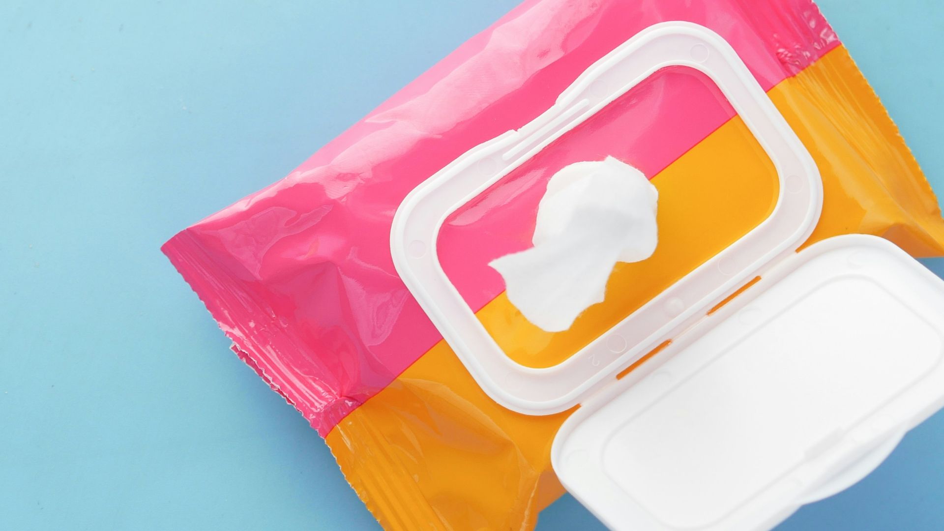 a pink and yellow bag of food on a blue surface