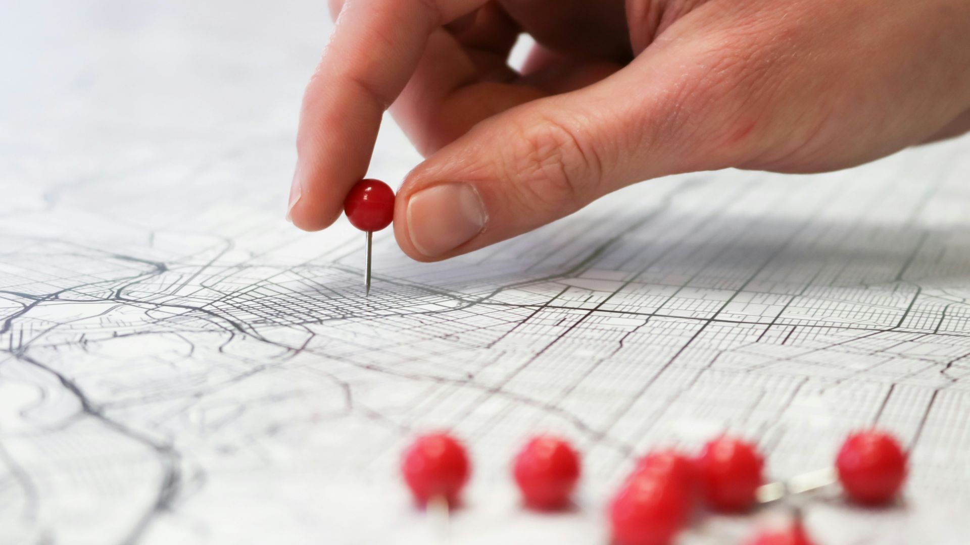 person holding red round medication pill