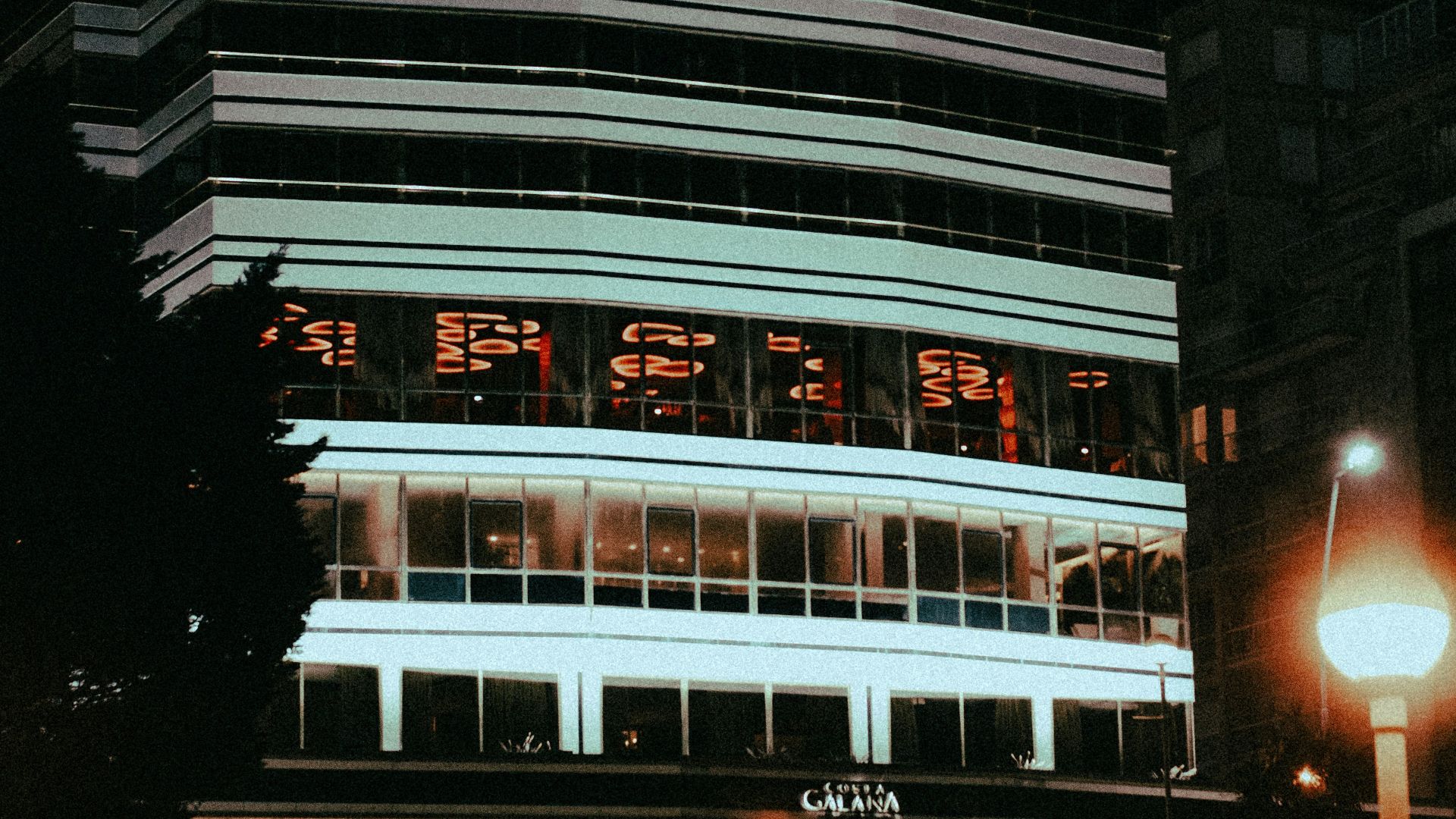 A tall building sitting next to a street light