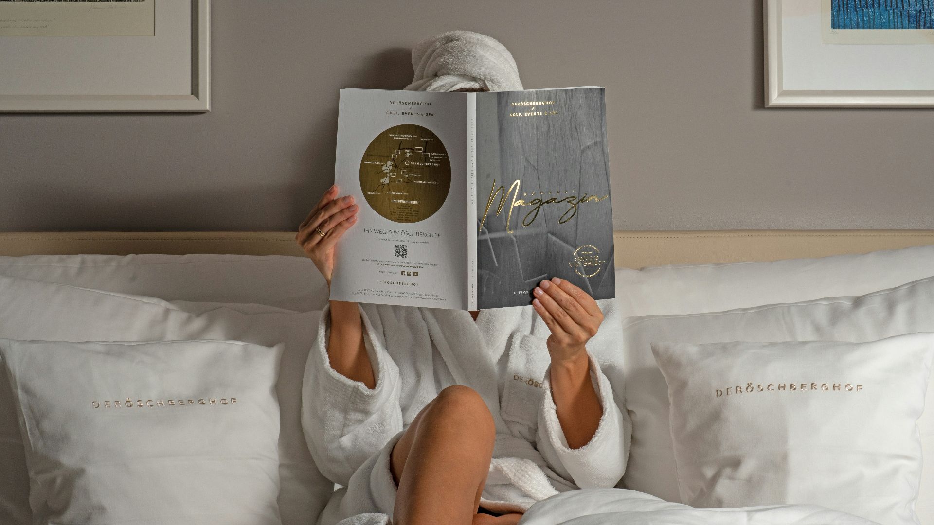 a person reading a book on a bed