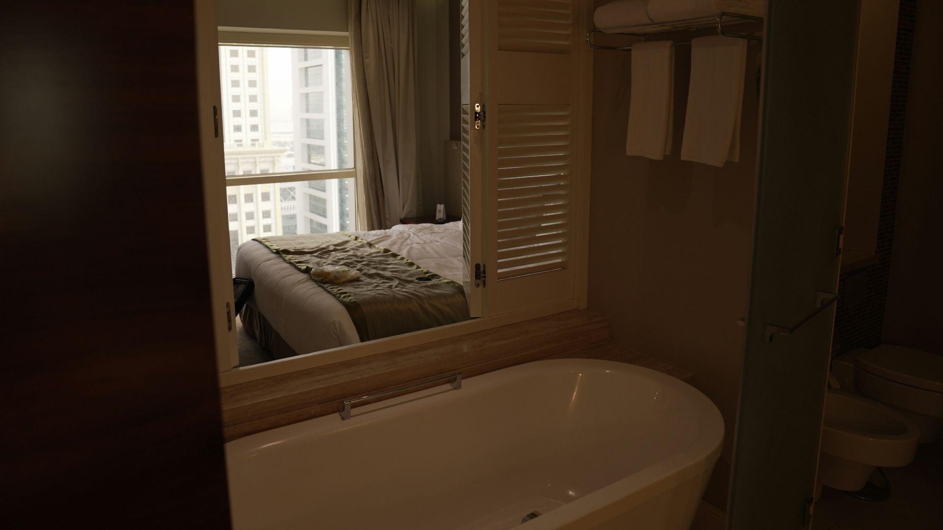 a bathroom with a tub and a large mirror