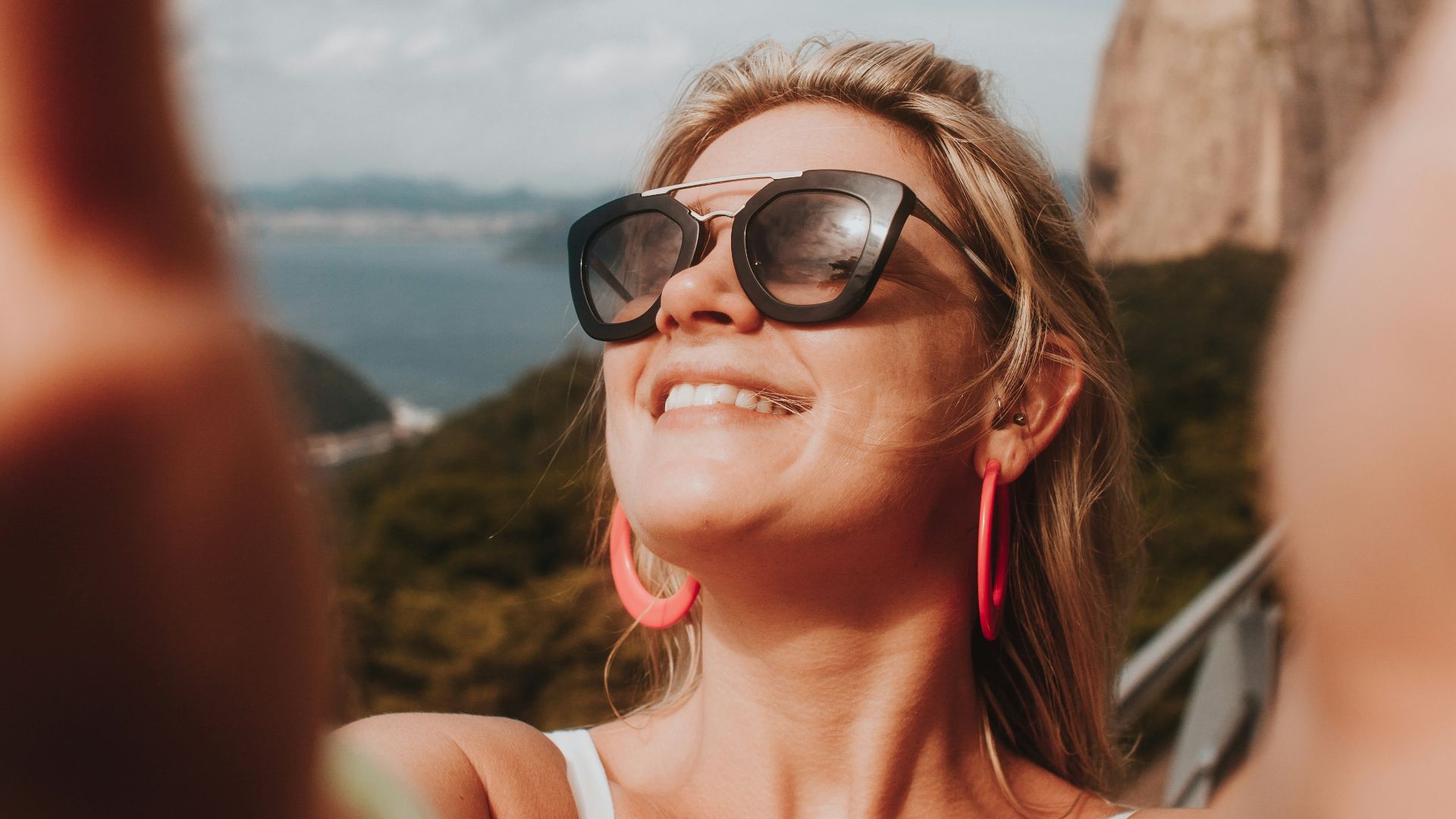 woman in white tank top wearing black sunglasses
