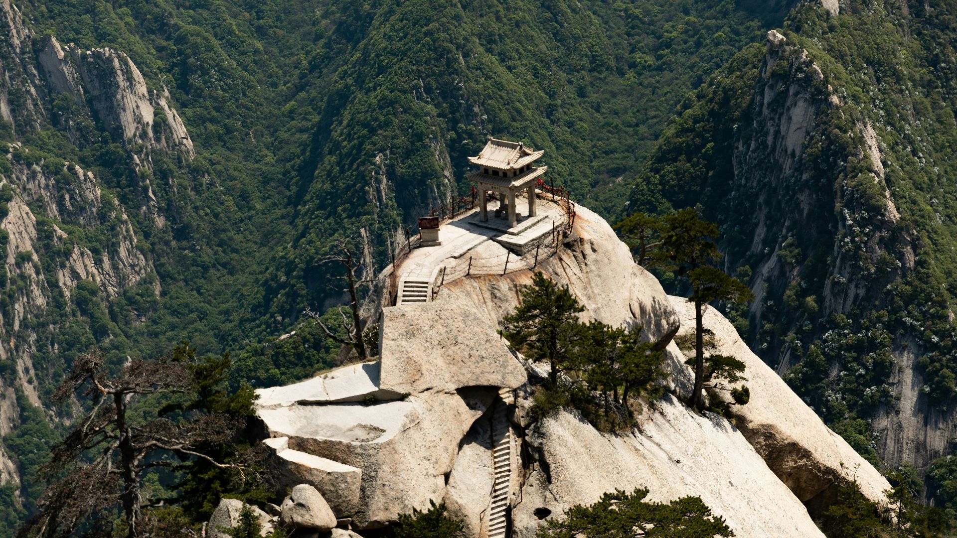 white and brown concrete building on mountain during daytime