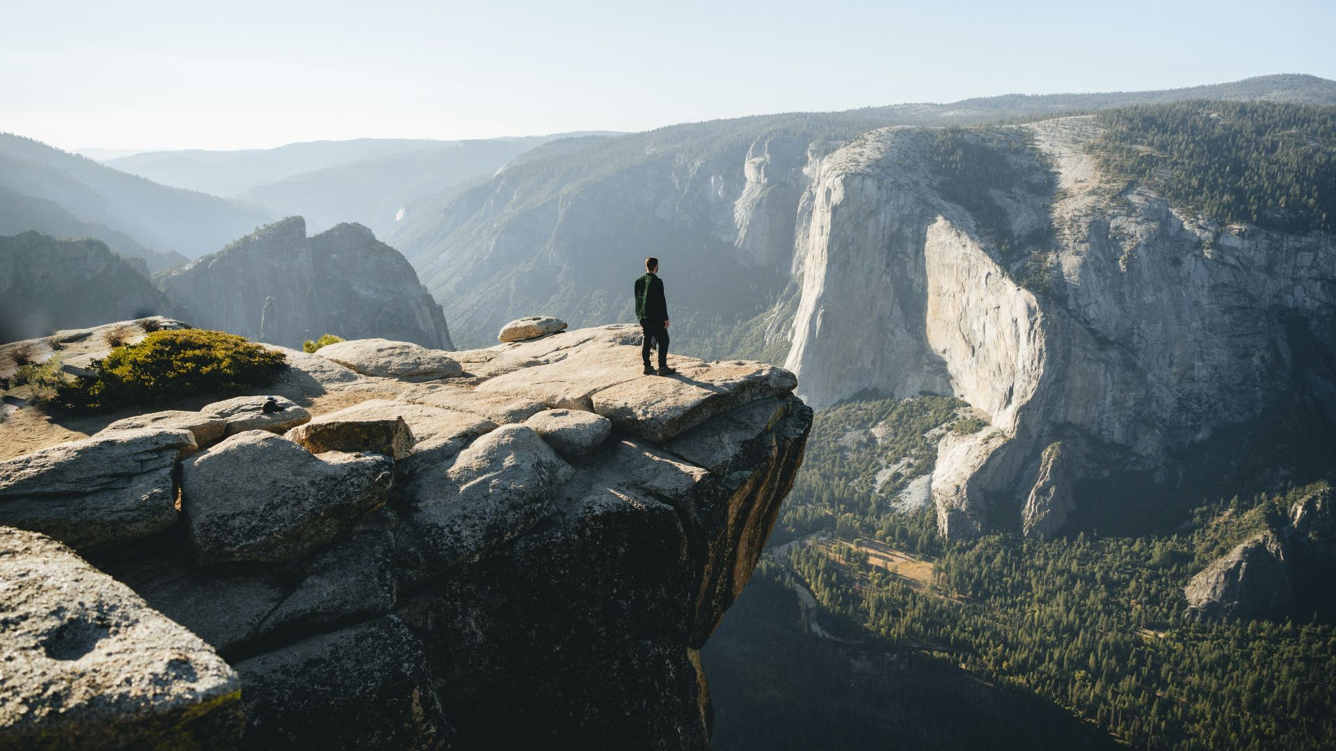 a person standing on top of a cliff