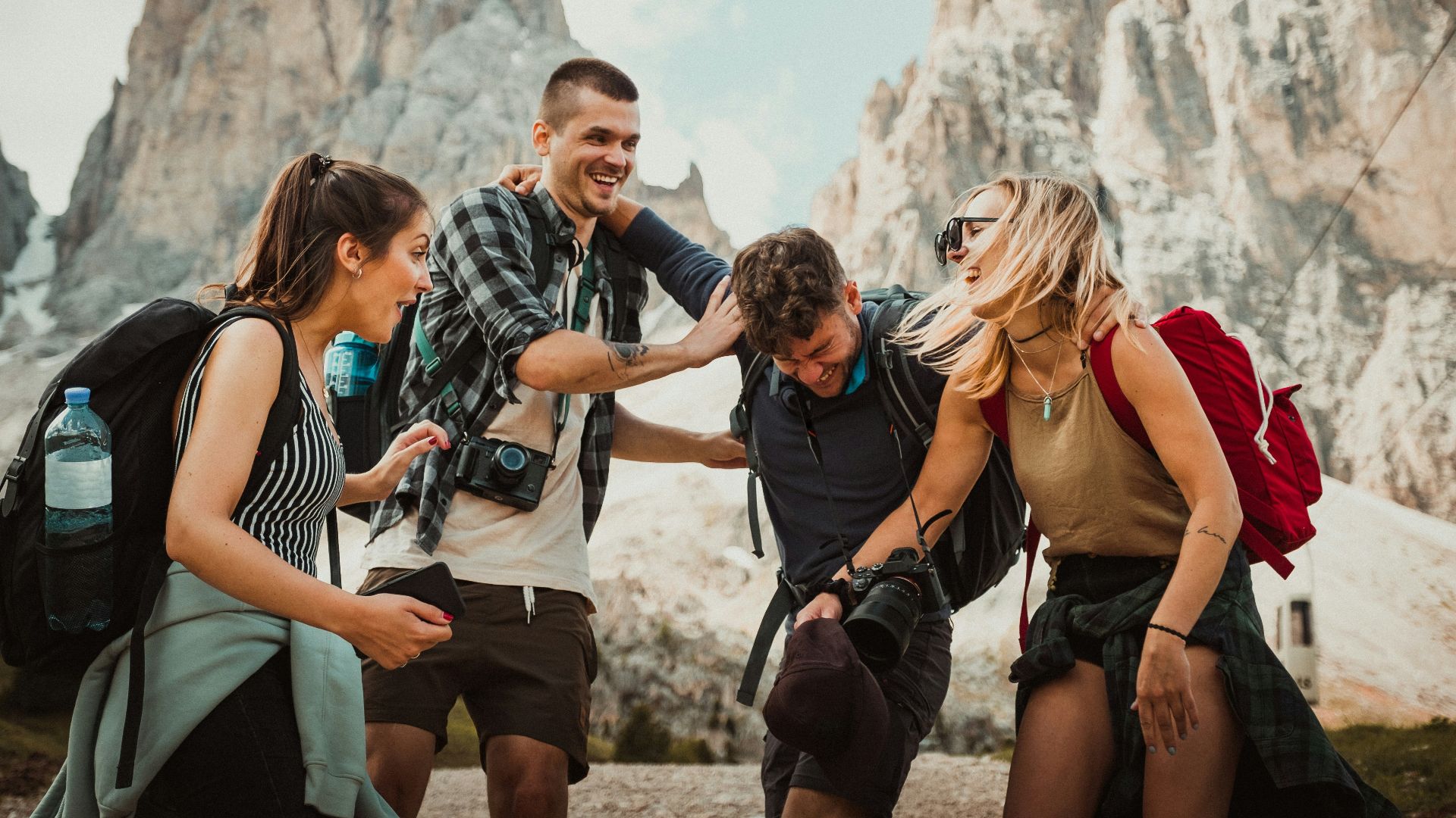 low-angle photography of two men playing beside two women
