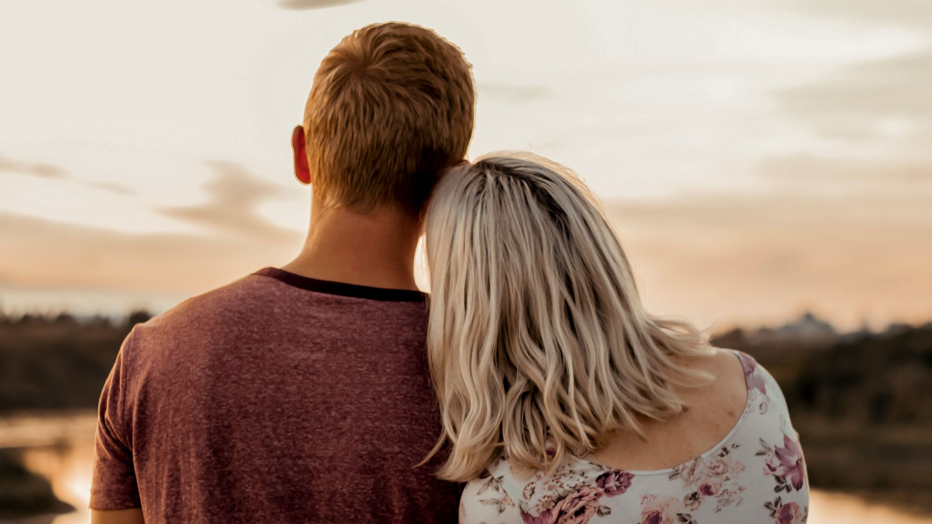 man and woman standing on brown field during daytime