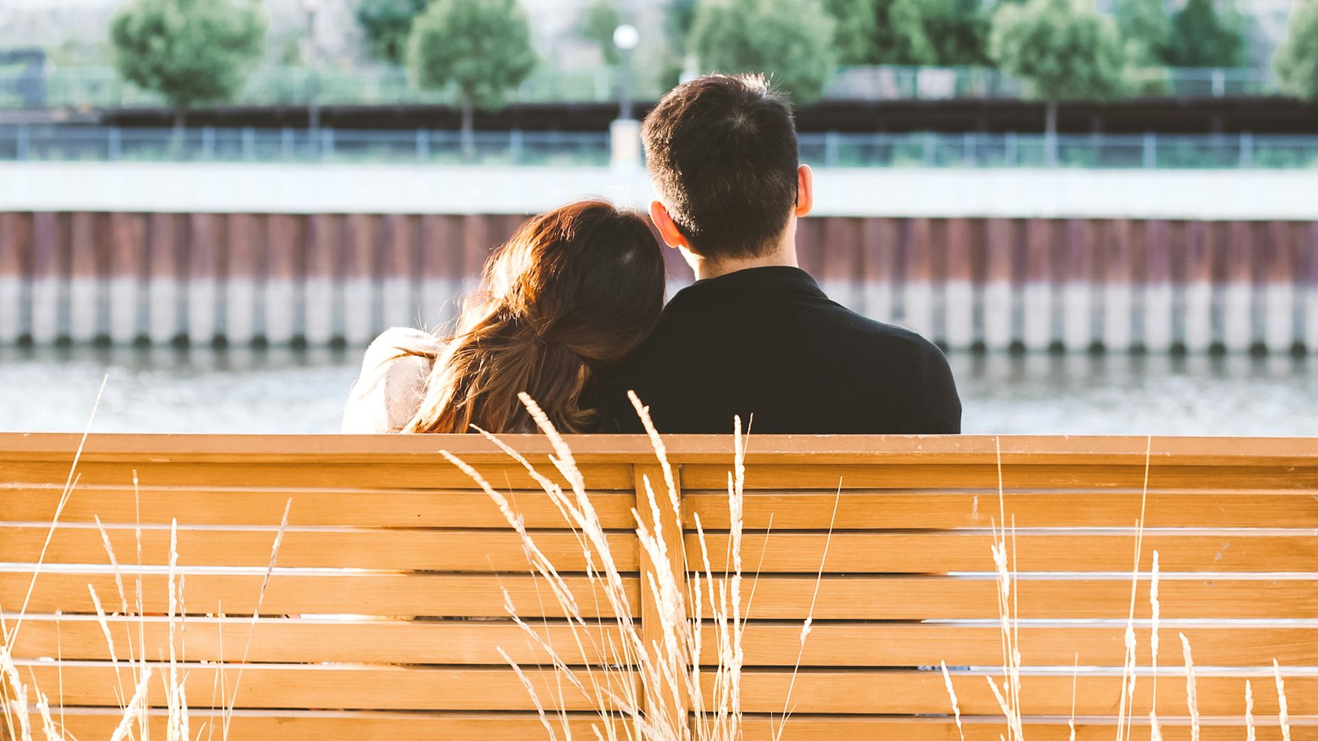 couple sitting on wooden bench