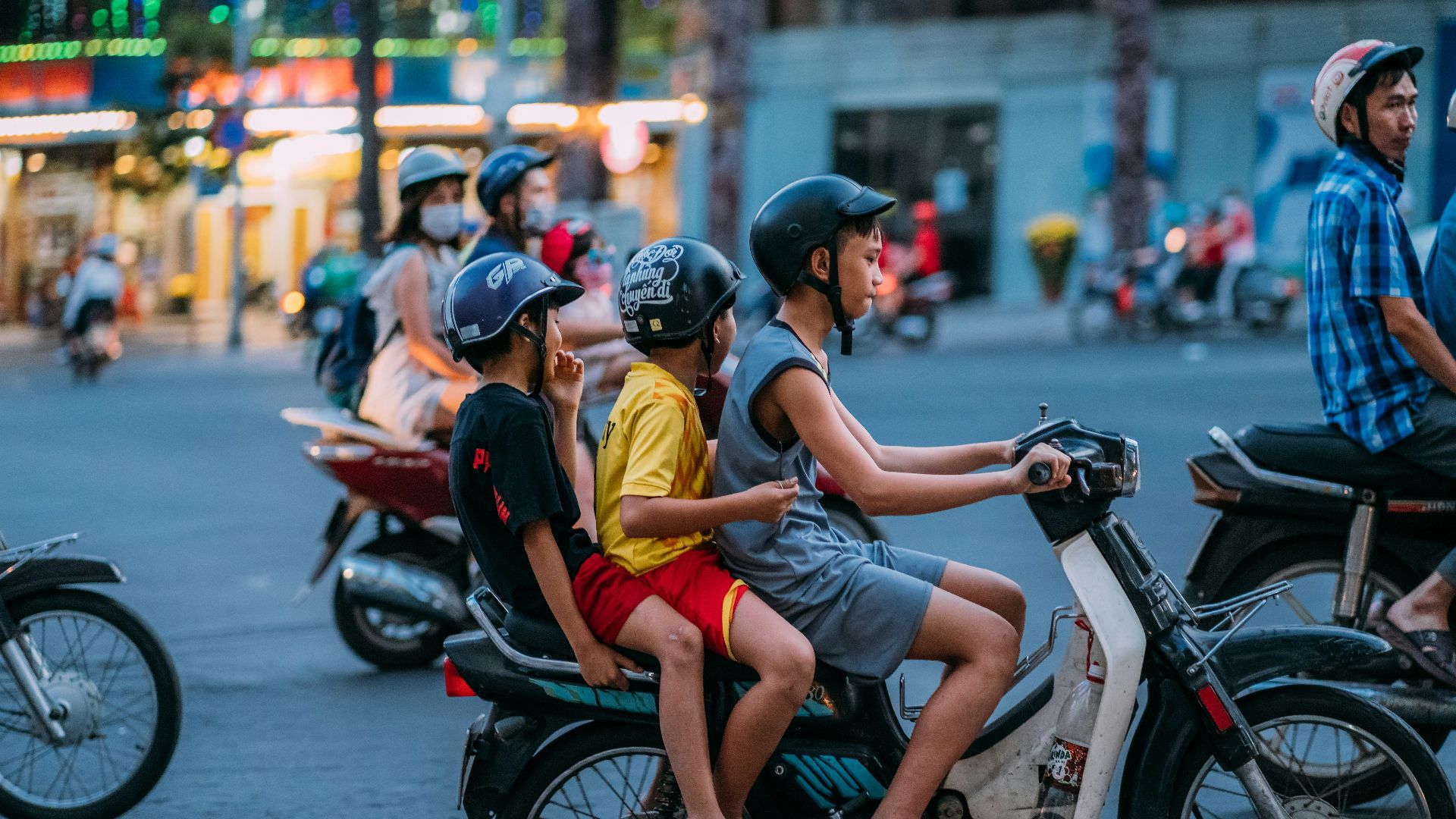 man in yellow shirt riding motorcycle with woman in yellow shirt