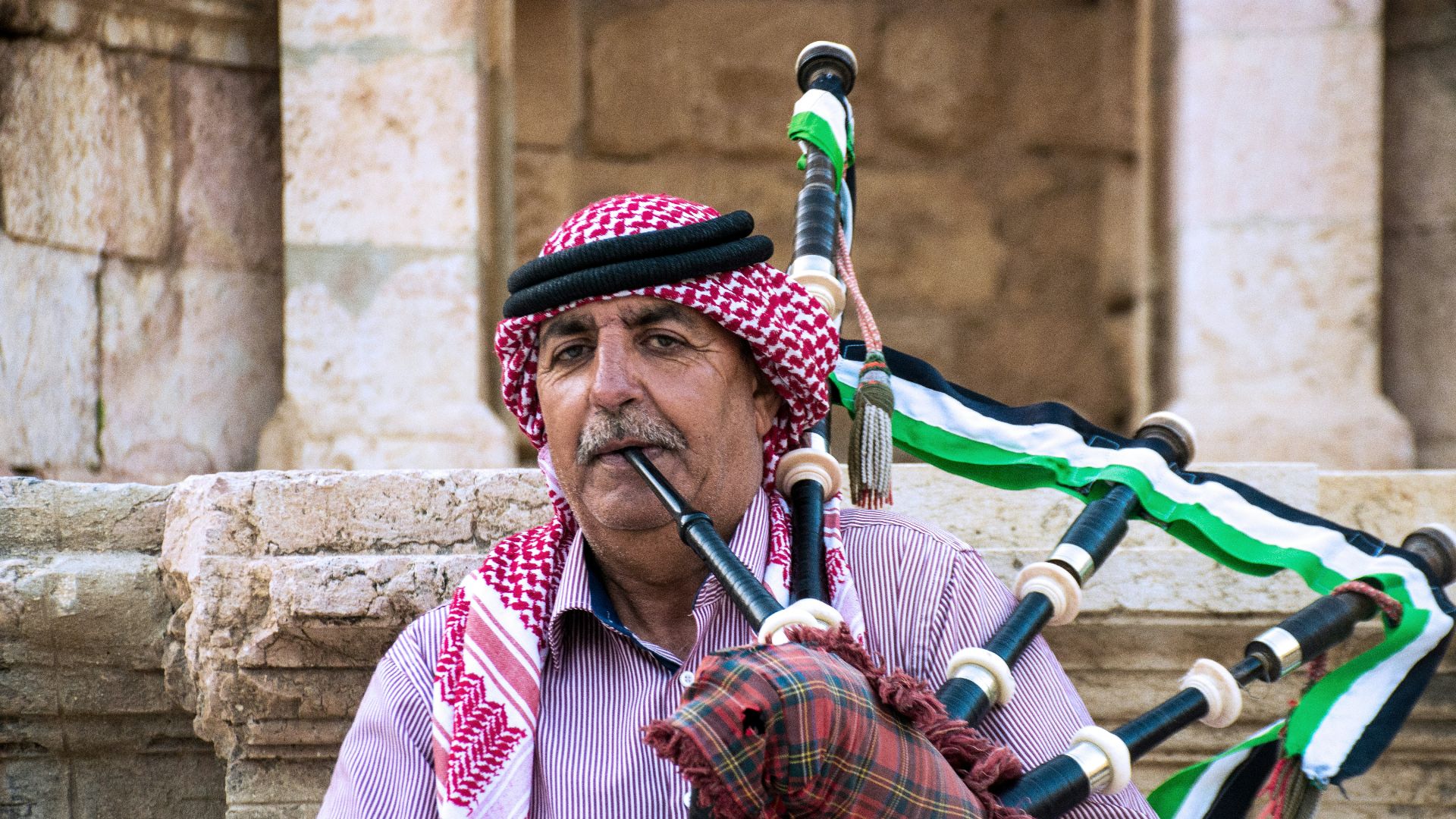 man in red and white stripe long sleeve shirt playing flute
