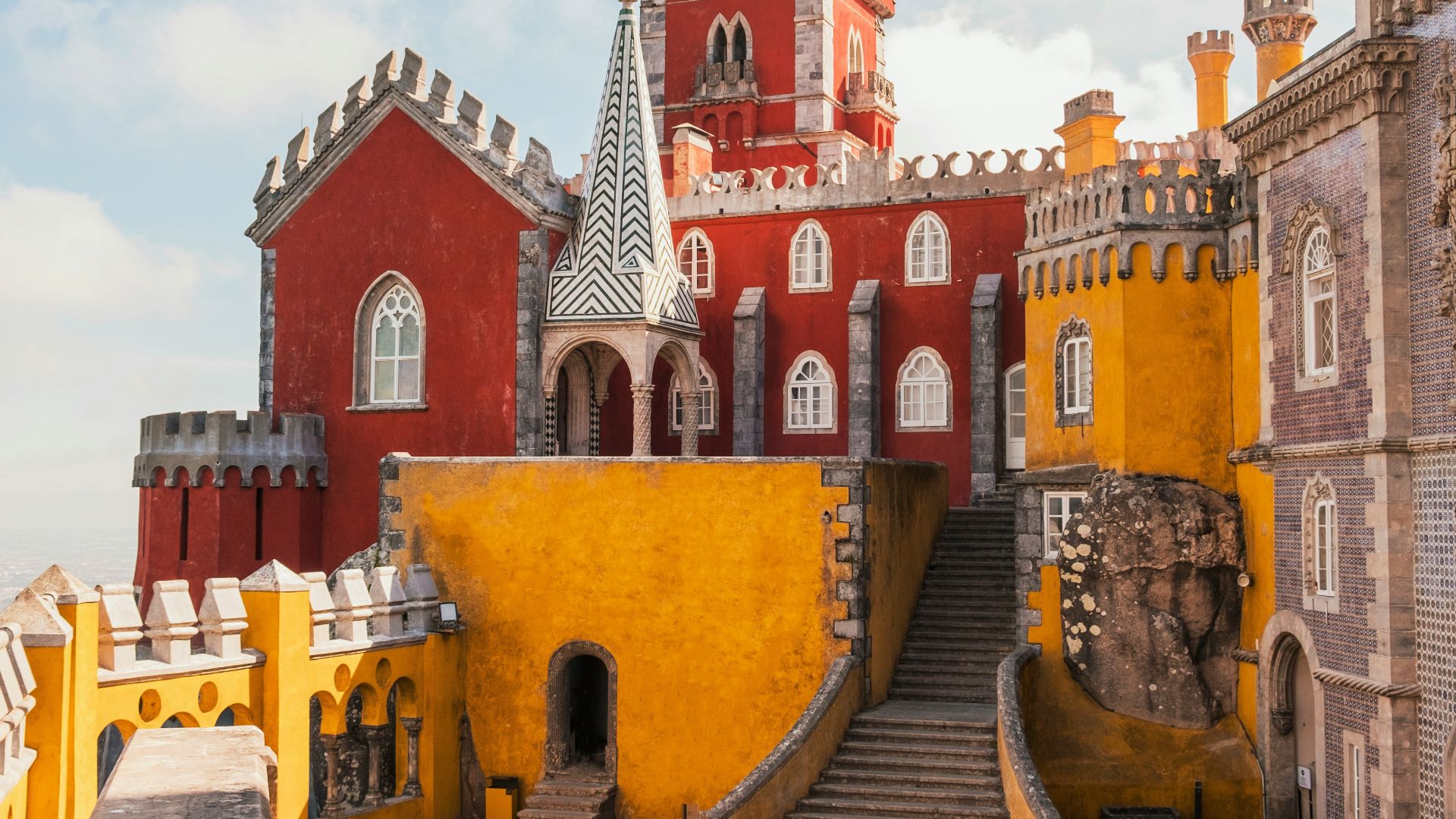 yellow and red concrete building under clear blue sky