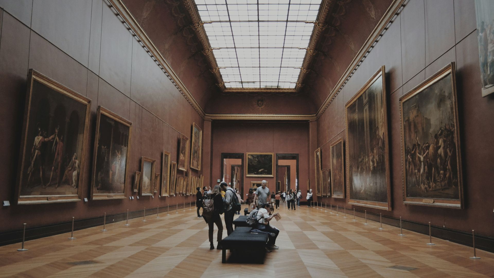 people walking on corridor looking at painting