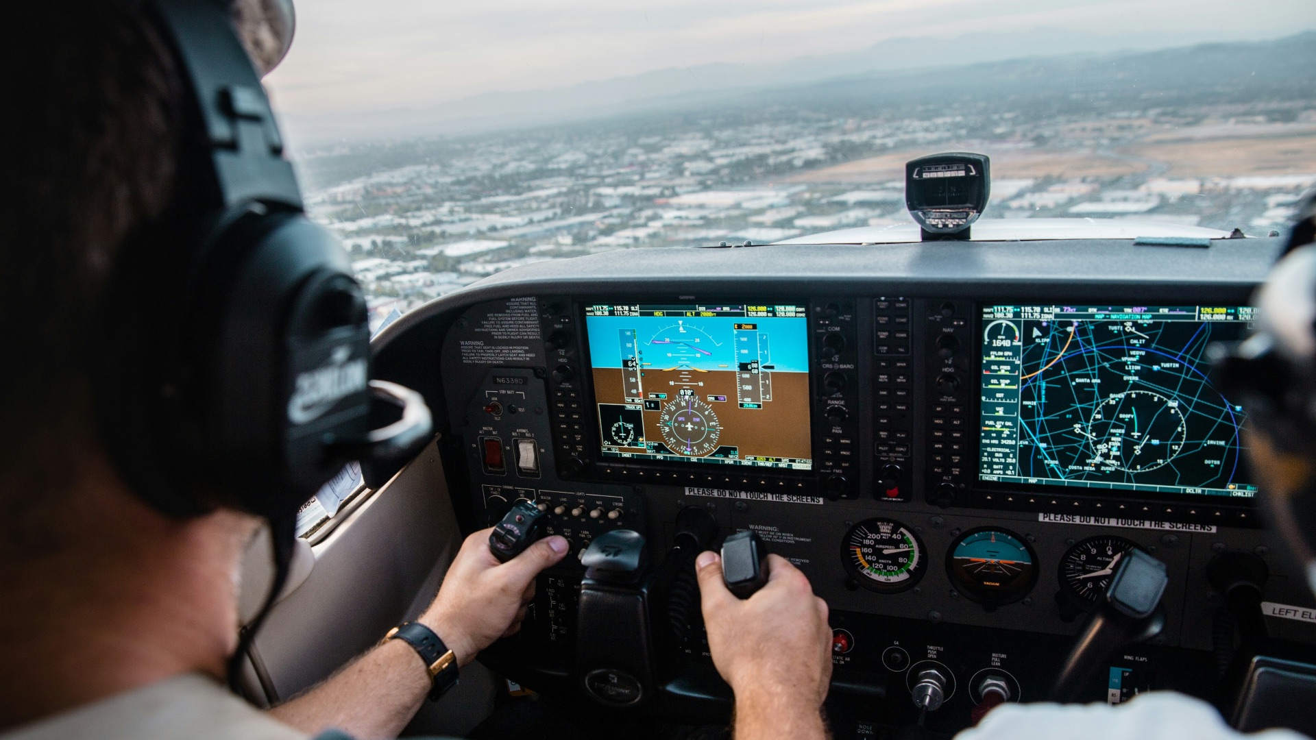 man flying aircraft under cloudy sky