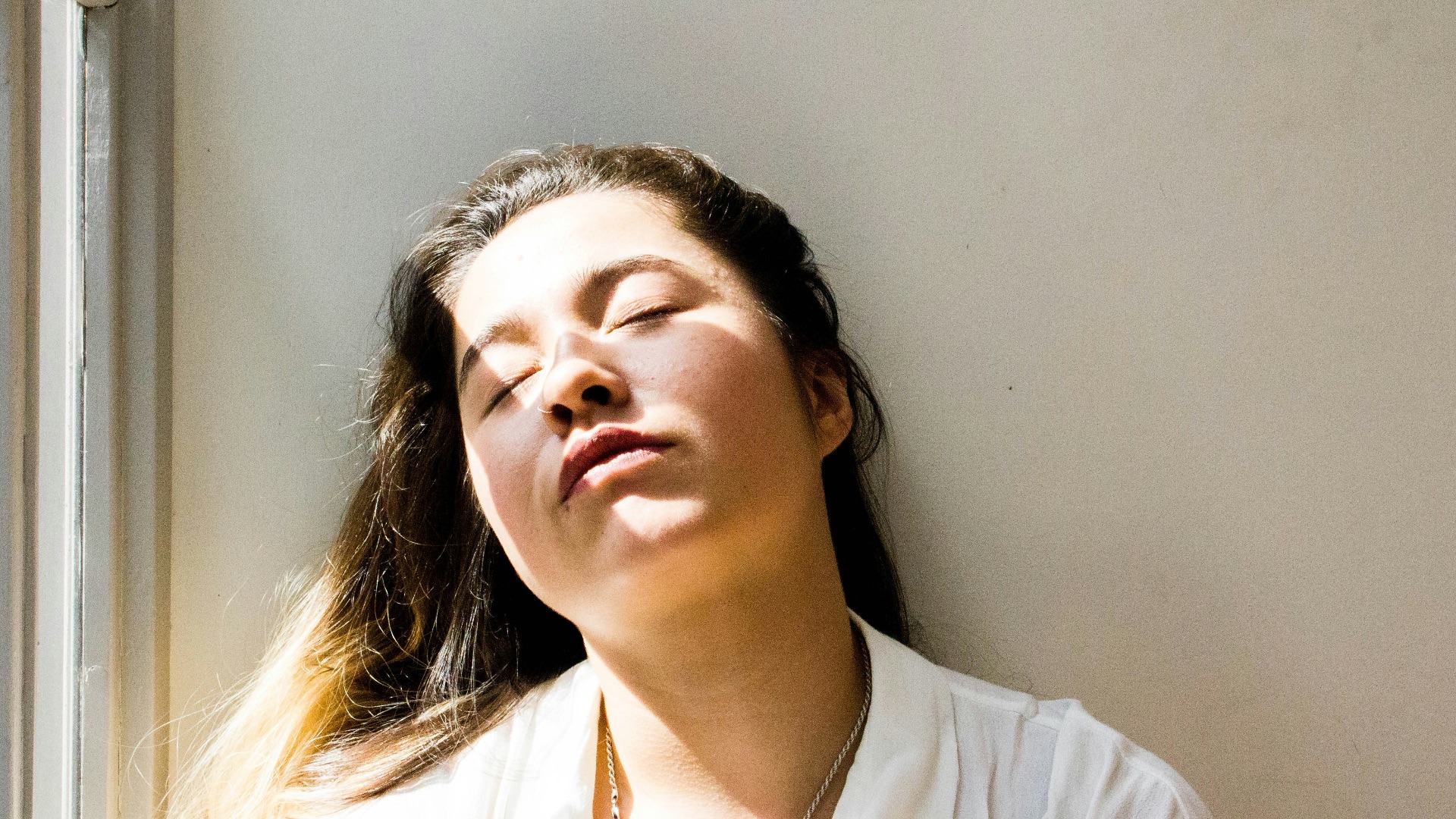 woman standing near window during daytime