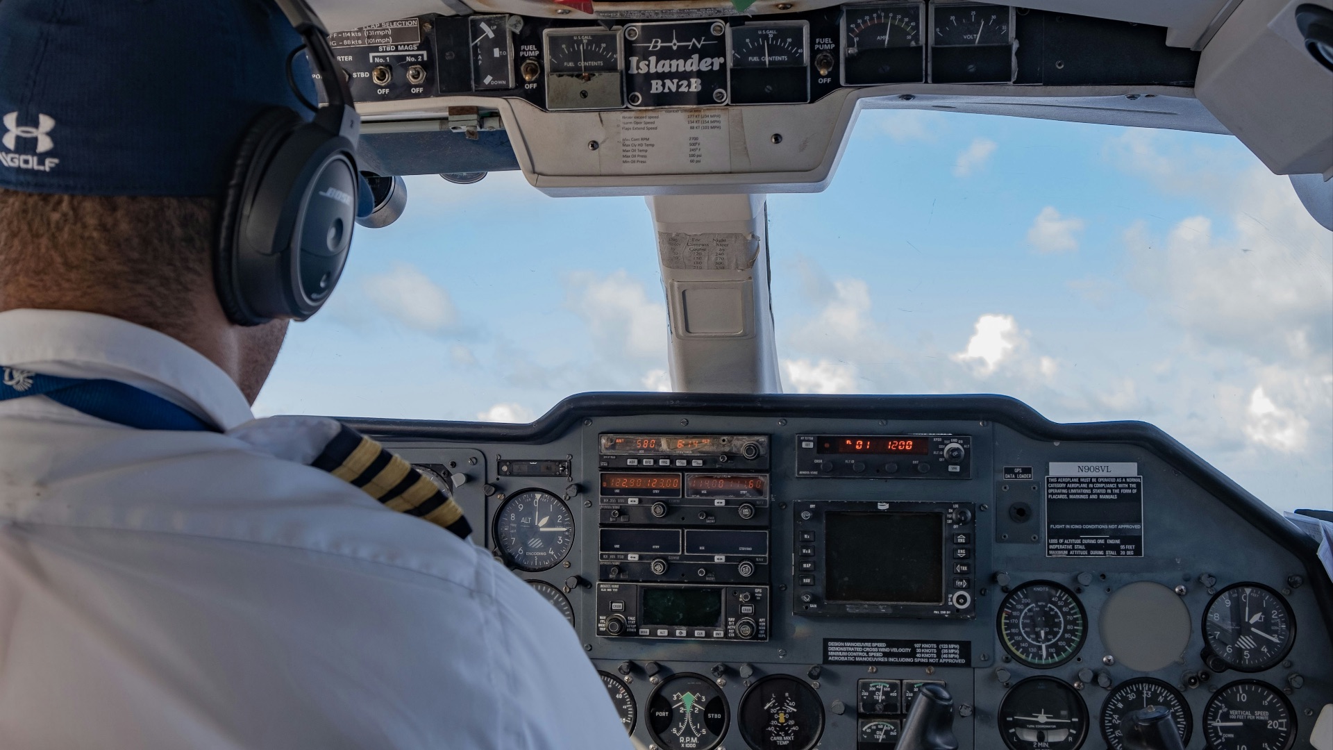 person in white shirt driving car