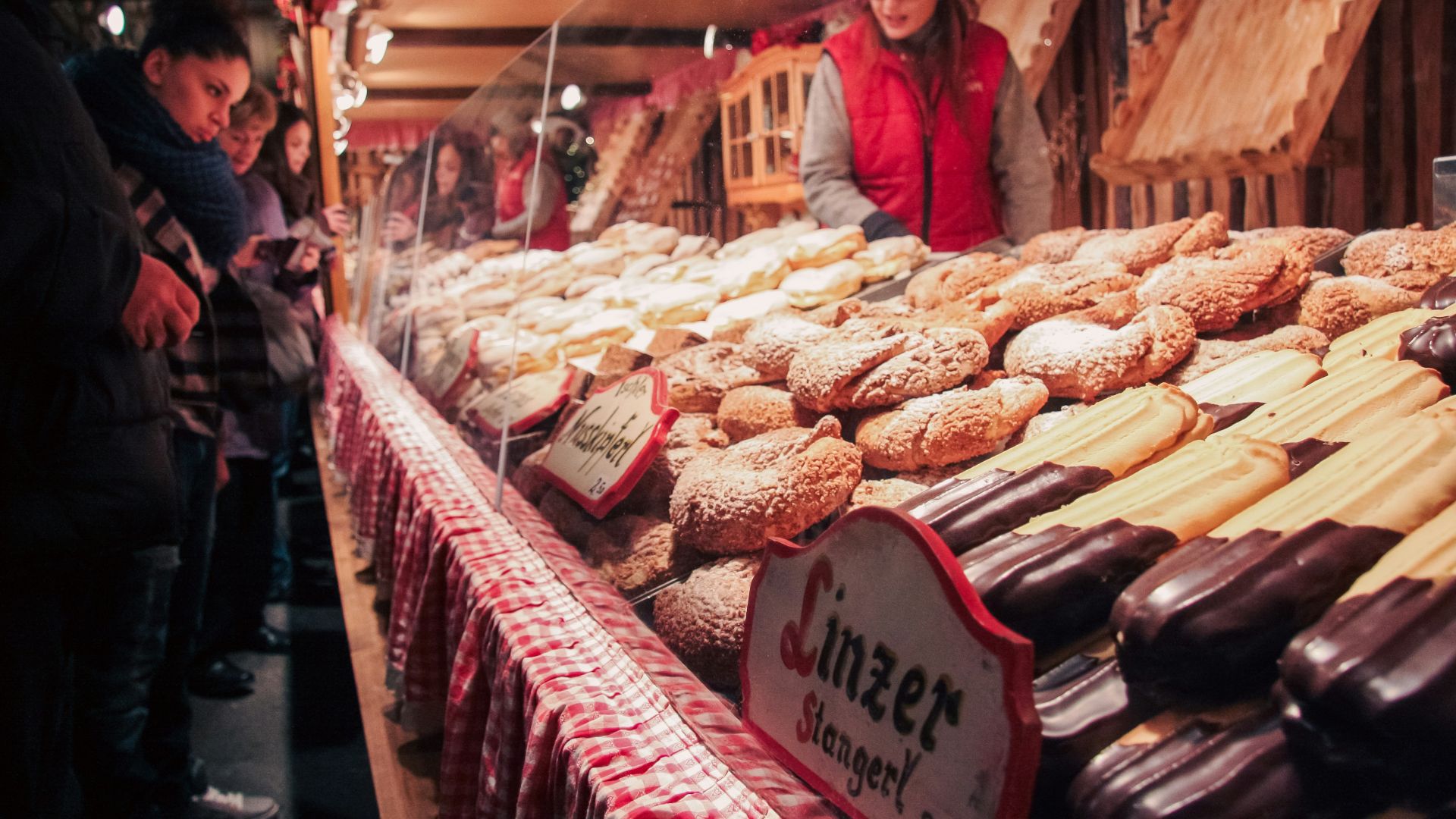 People buying pastries at a market stall