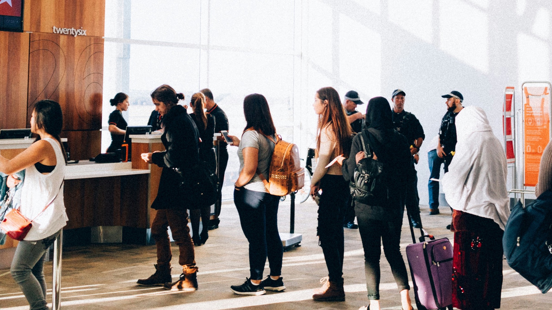 a group of people standing in a large room