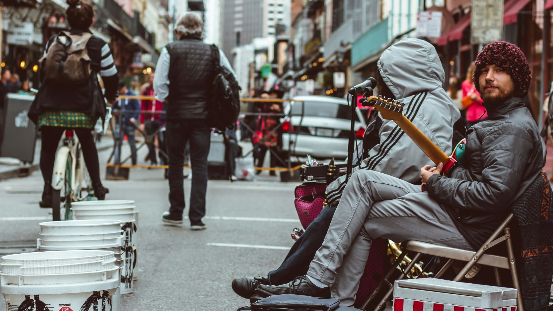 people at the streets near a live band