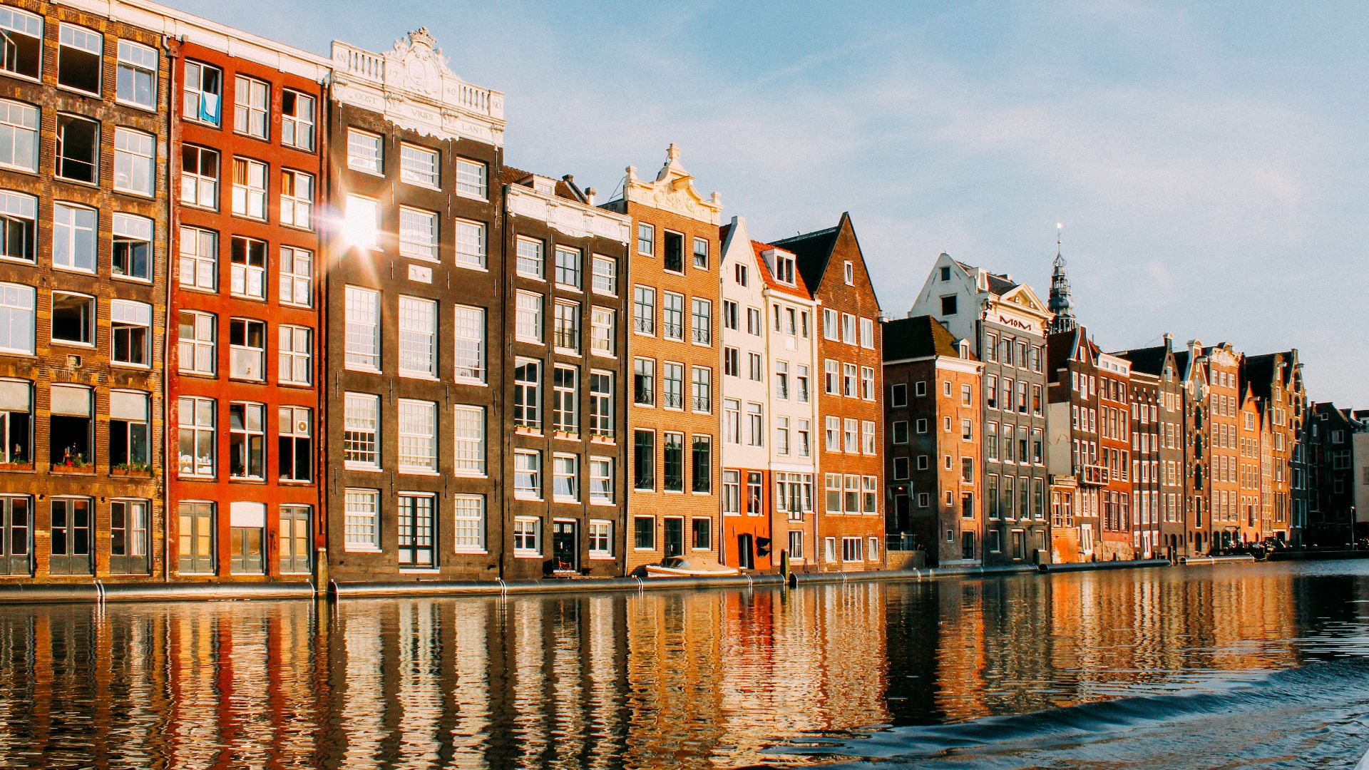 assorted-color buildings beside body of water