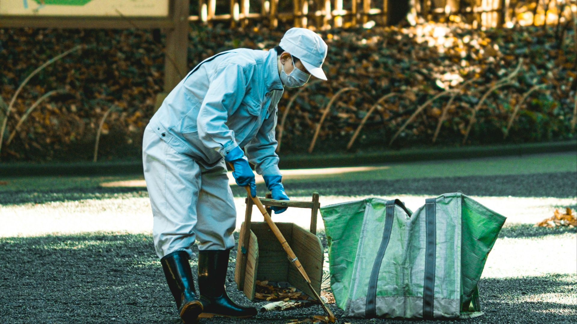 a man in a white suit and hat with a shovel