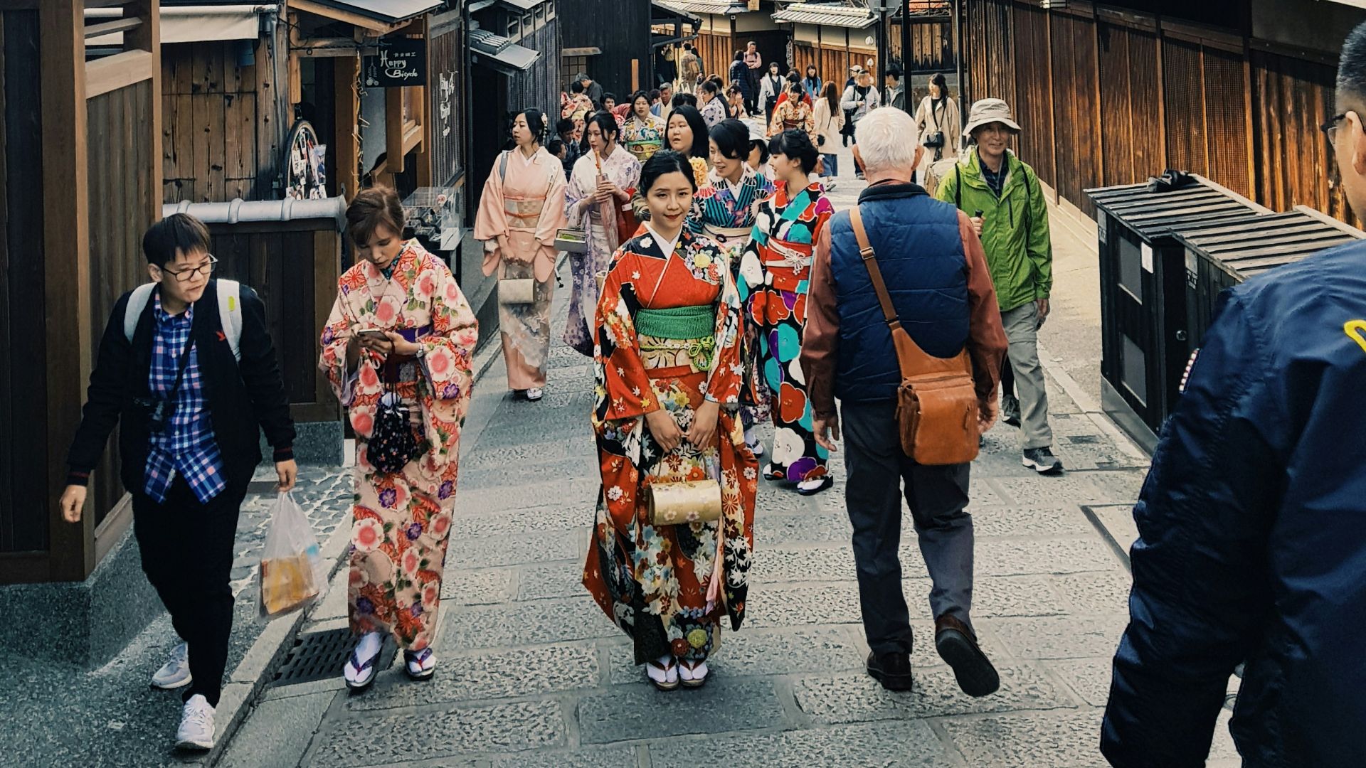 people walking along road leading to a pagoda