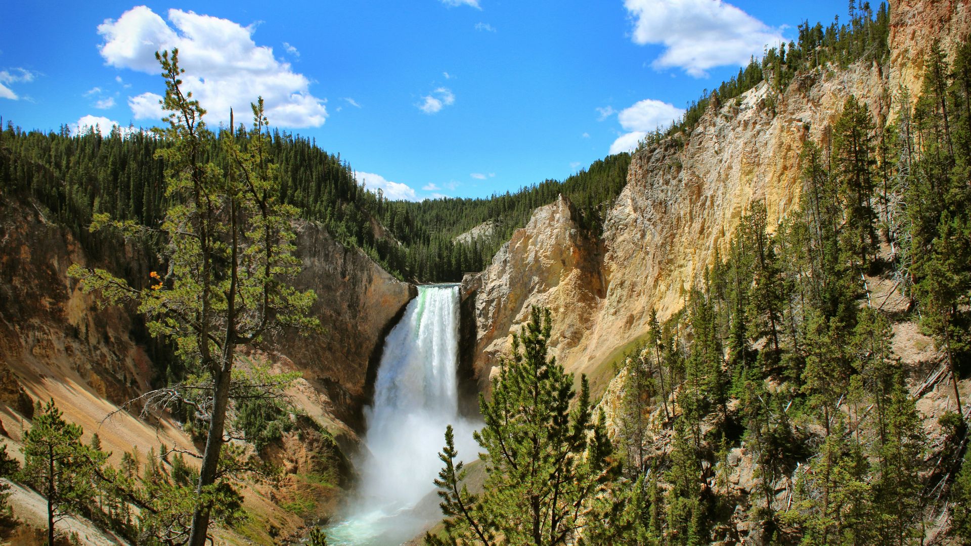 waterfalls under blue sky during daytime