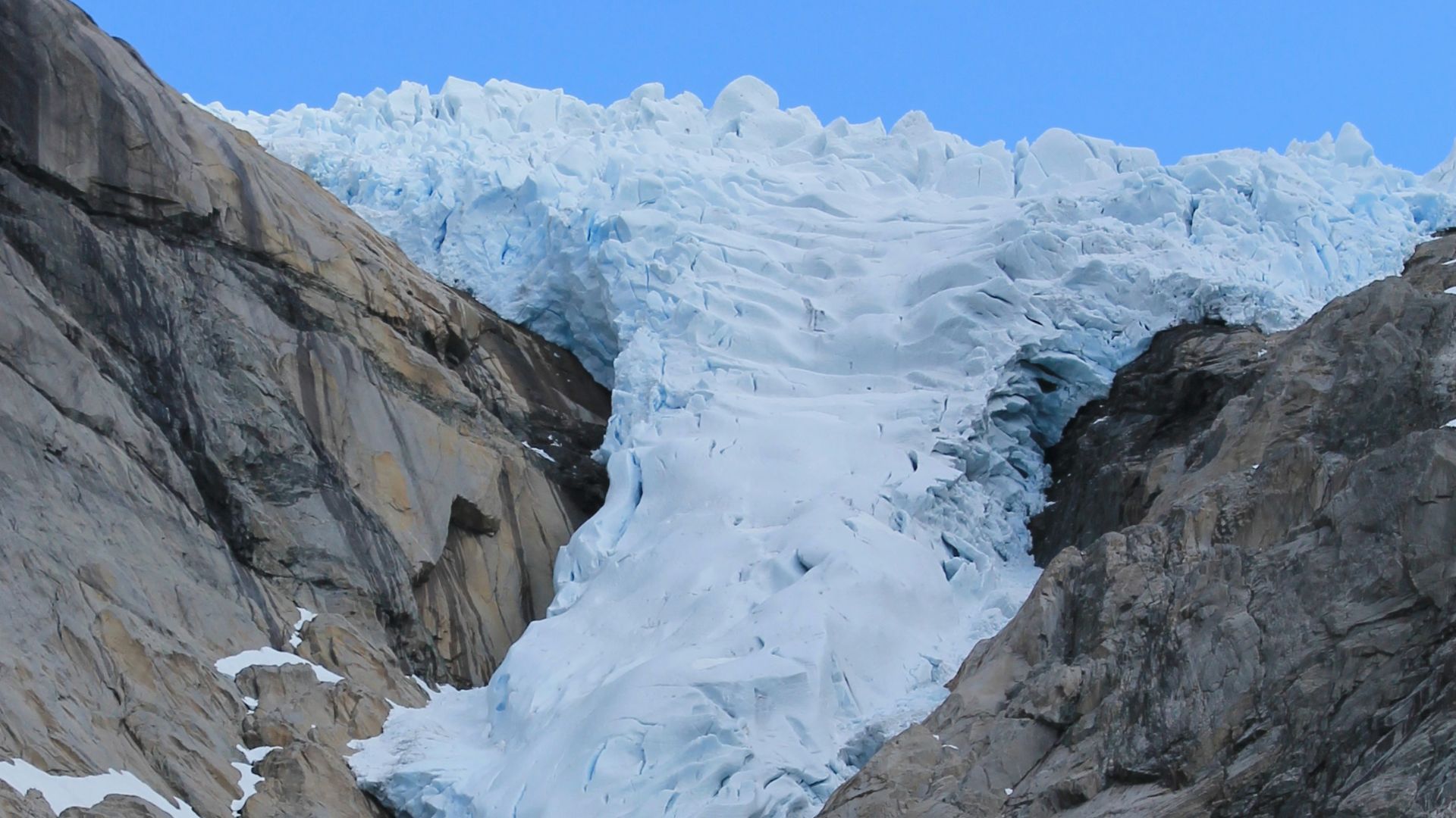 a mountain side with a very large glacier on it