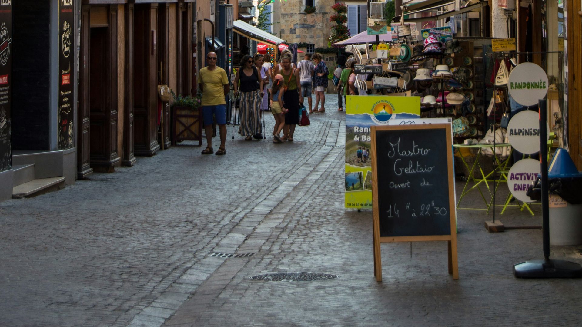 A narrow street with a sign on the side of it