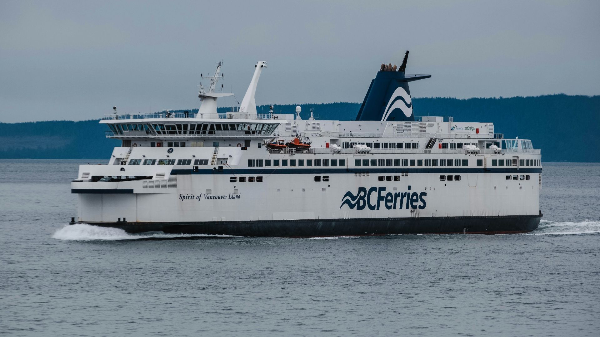 a large white boat traveling across a large body of water
