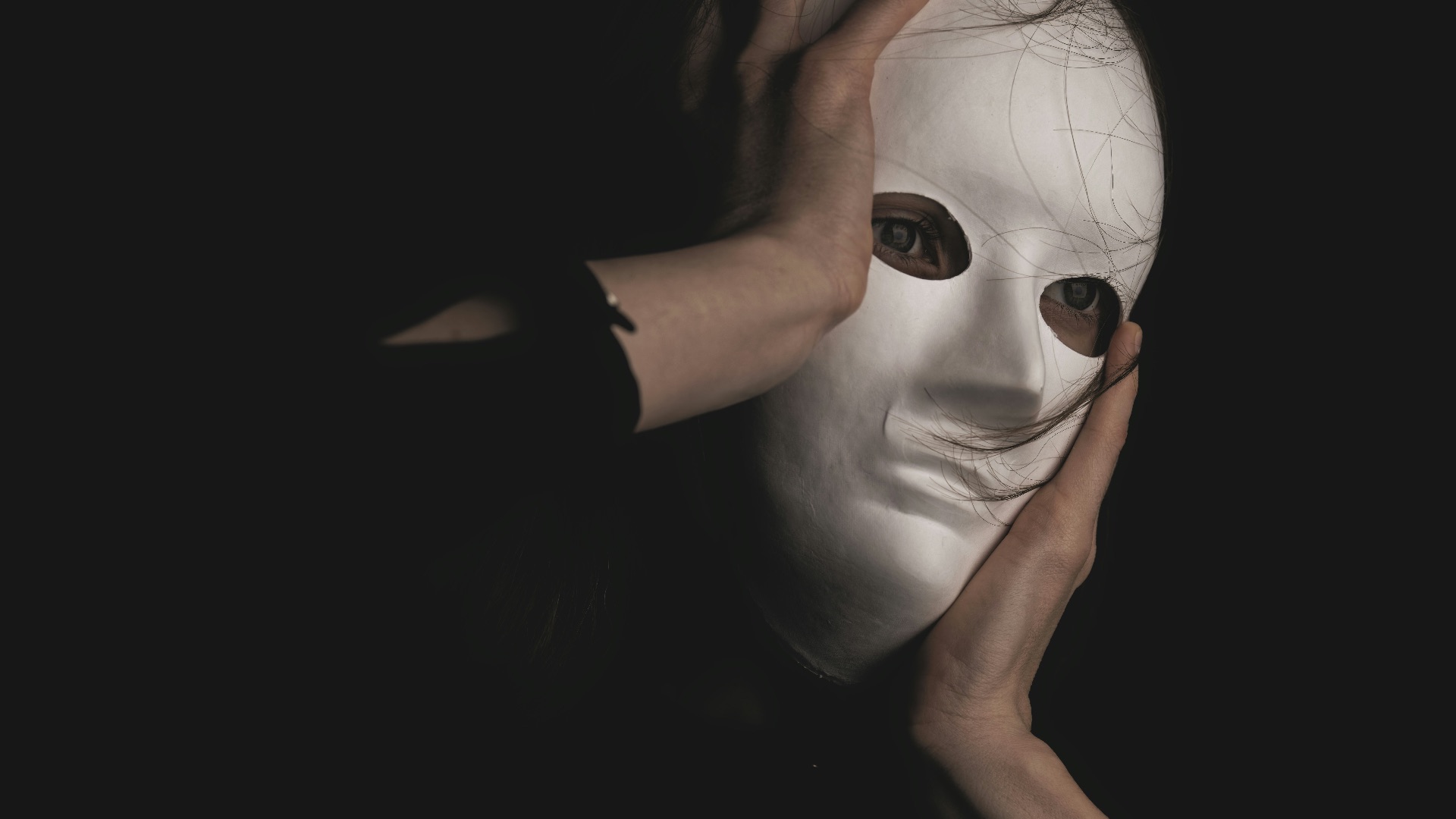 person in black long sleeve shirt covering face with face