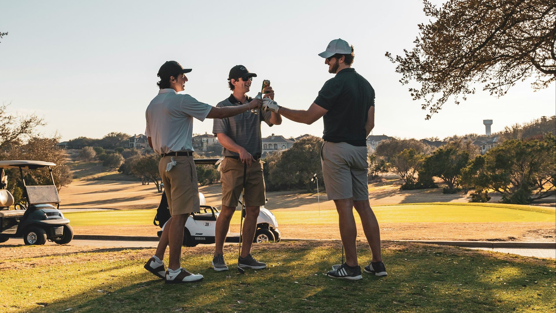 man in black t-shirt and brown shorts playing golf during daytime