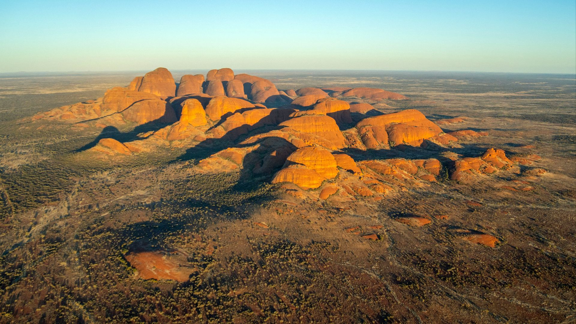 Golden desert landscape with rock formations at sunrise