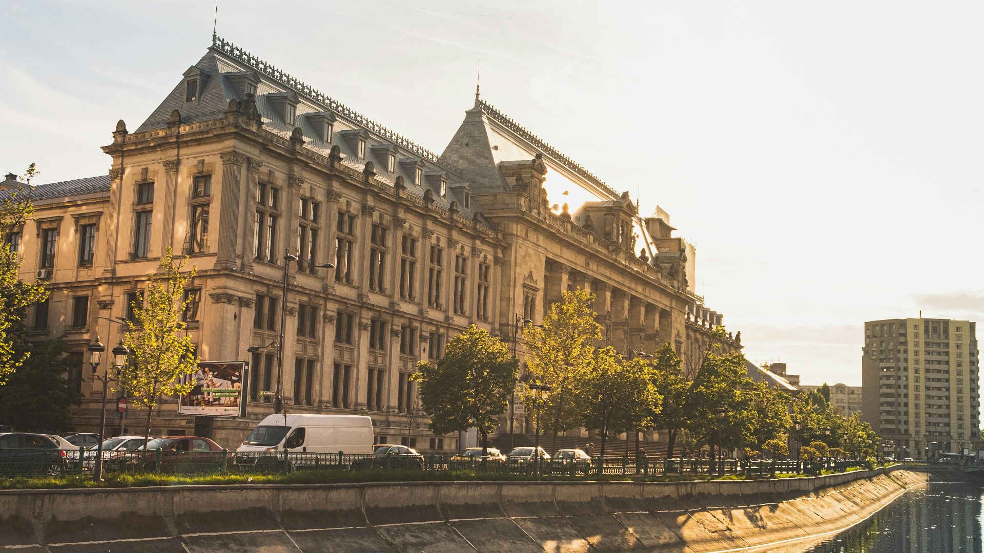 brown concrete building near river during daytime