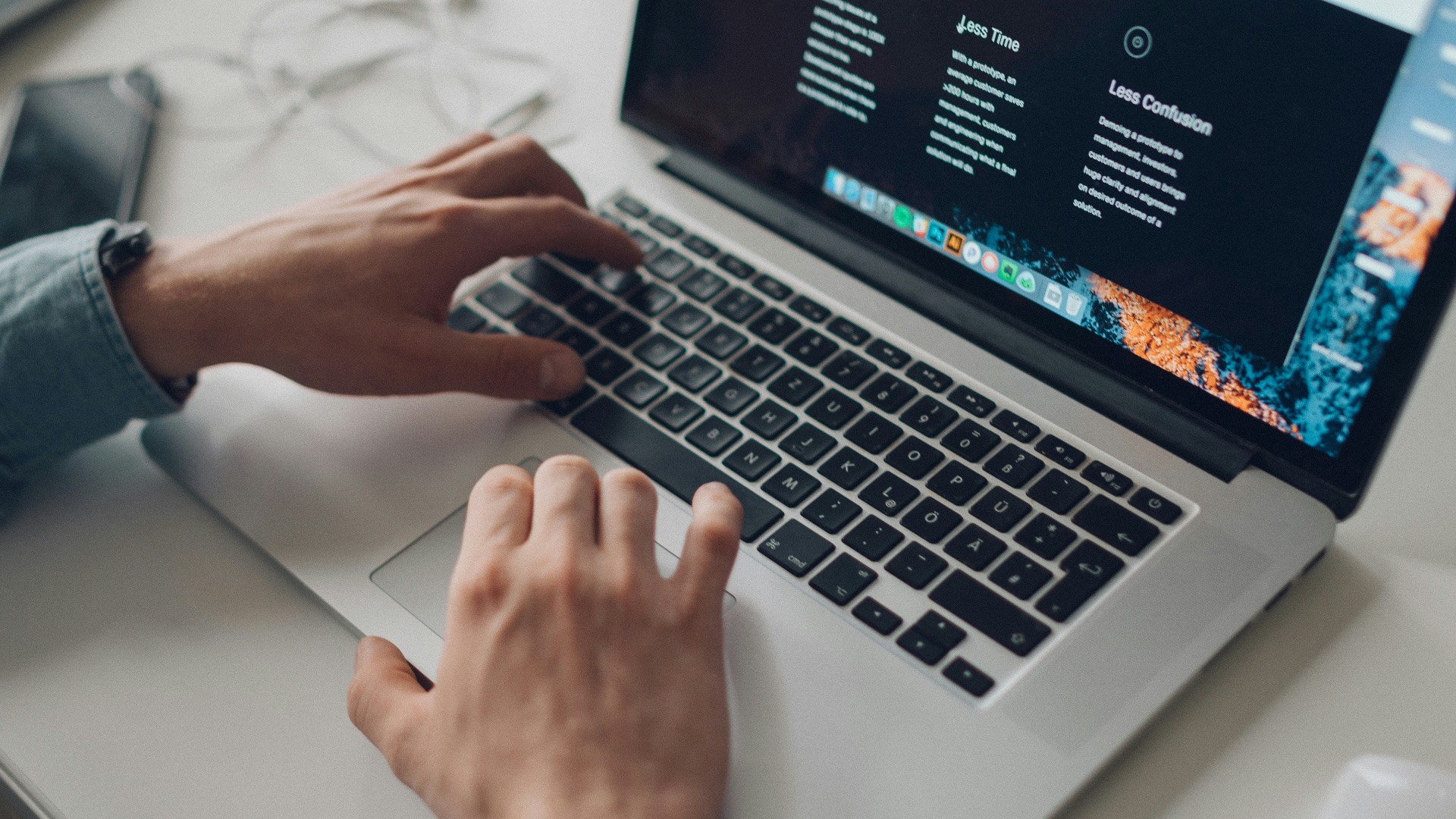 person wearing long-sleeve top working on laptop