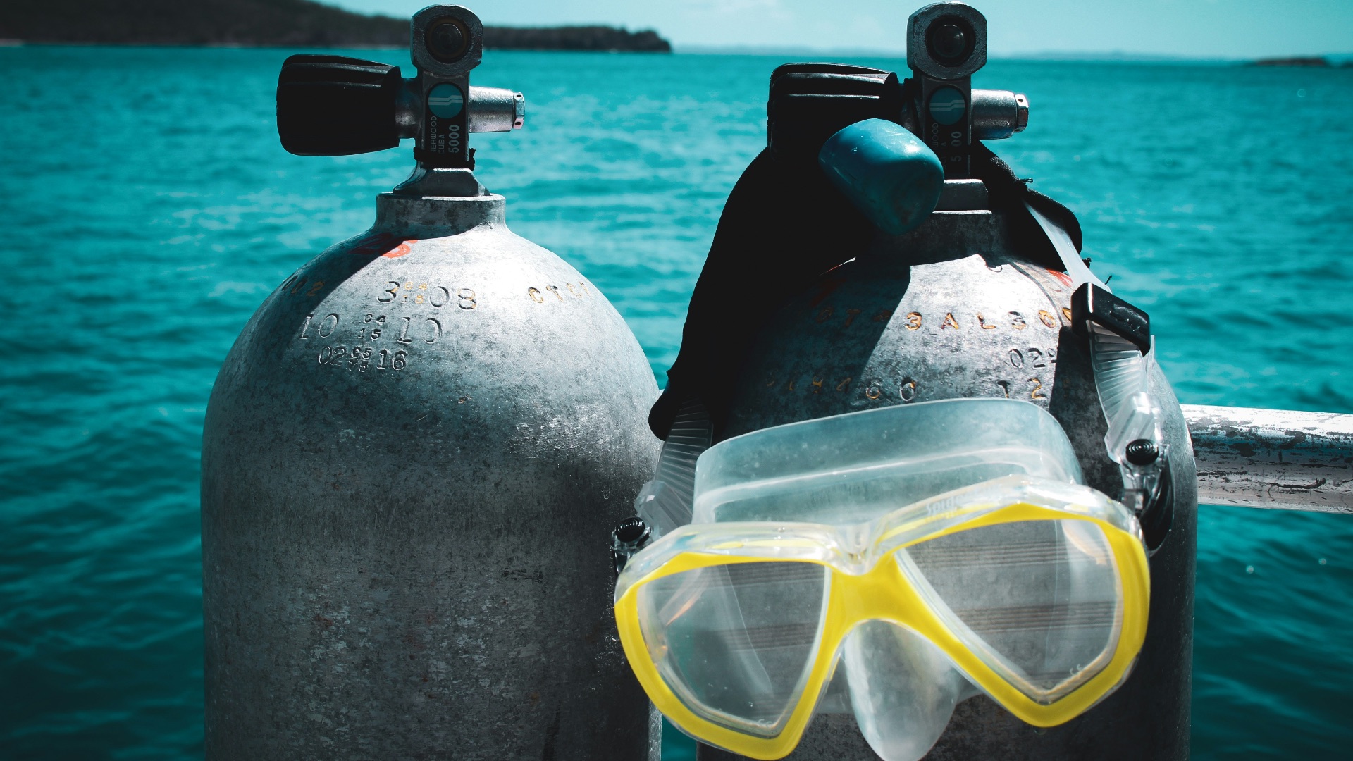 a pair of scuba goggles sitting on top of two buoys