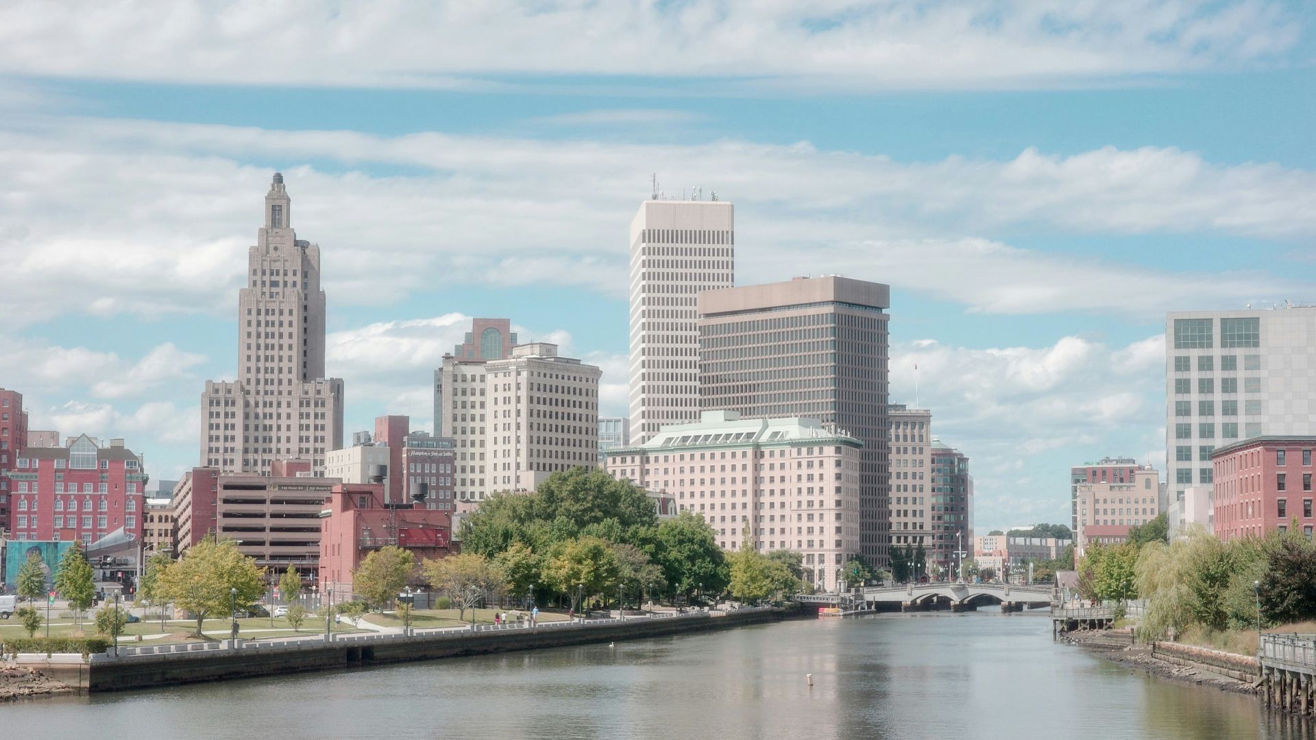 A river running through a city next to tall buildings