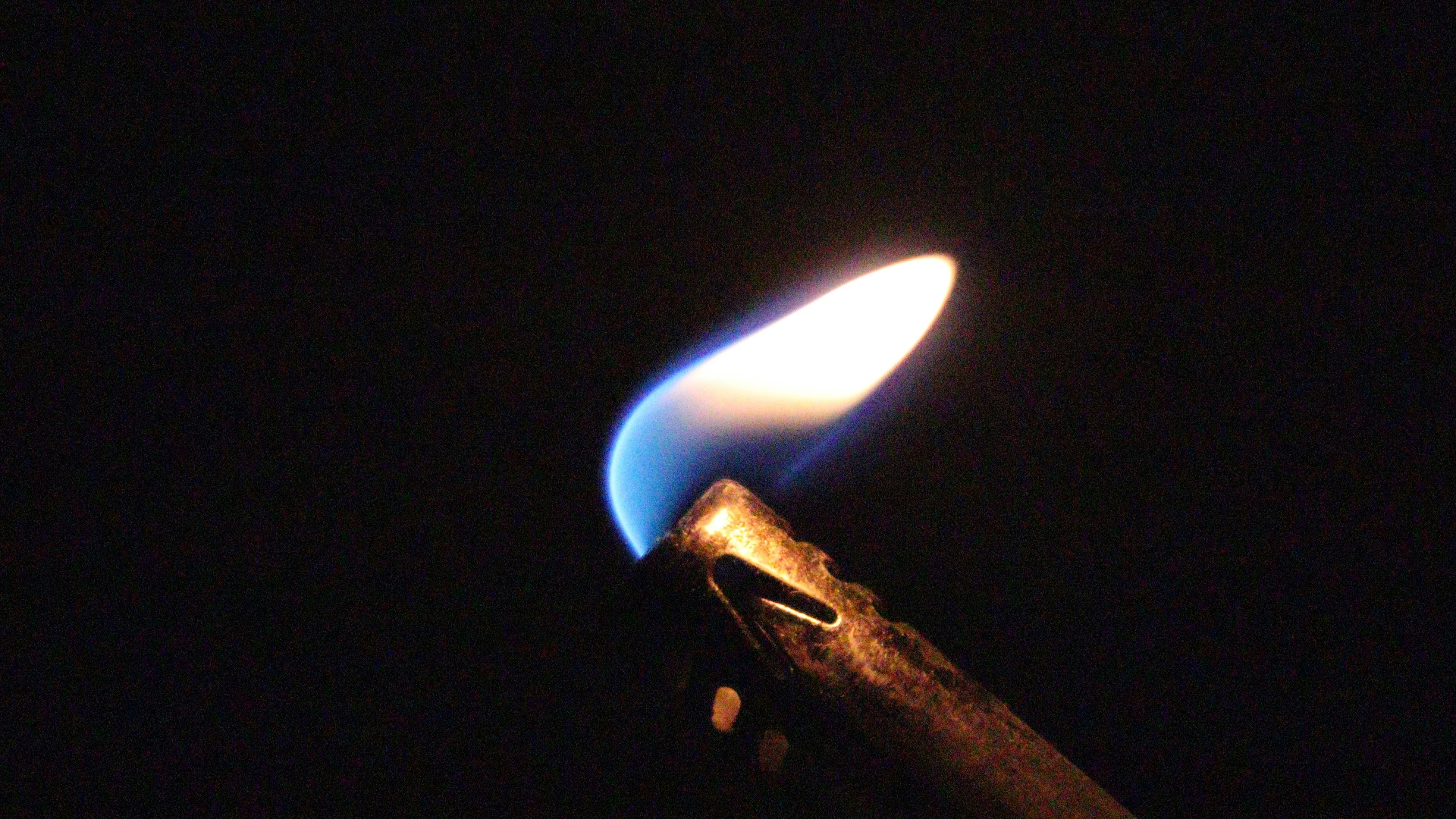 brass-colored lighter with fire