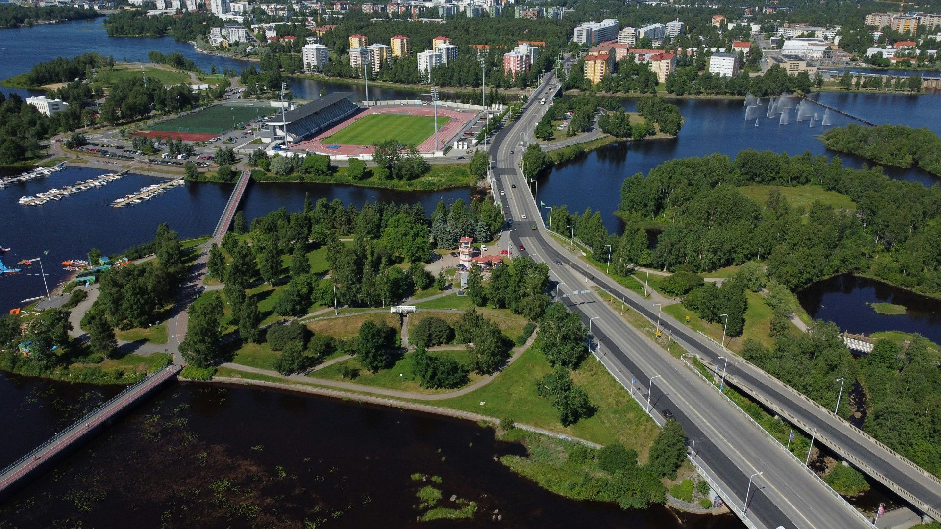 a river with a bridge and trees