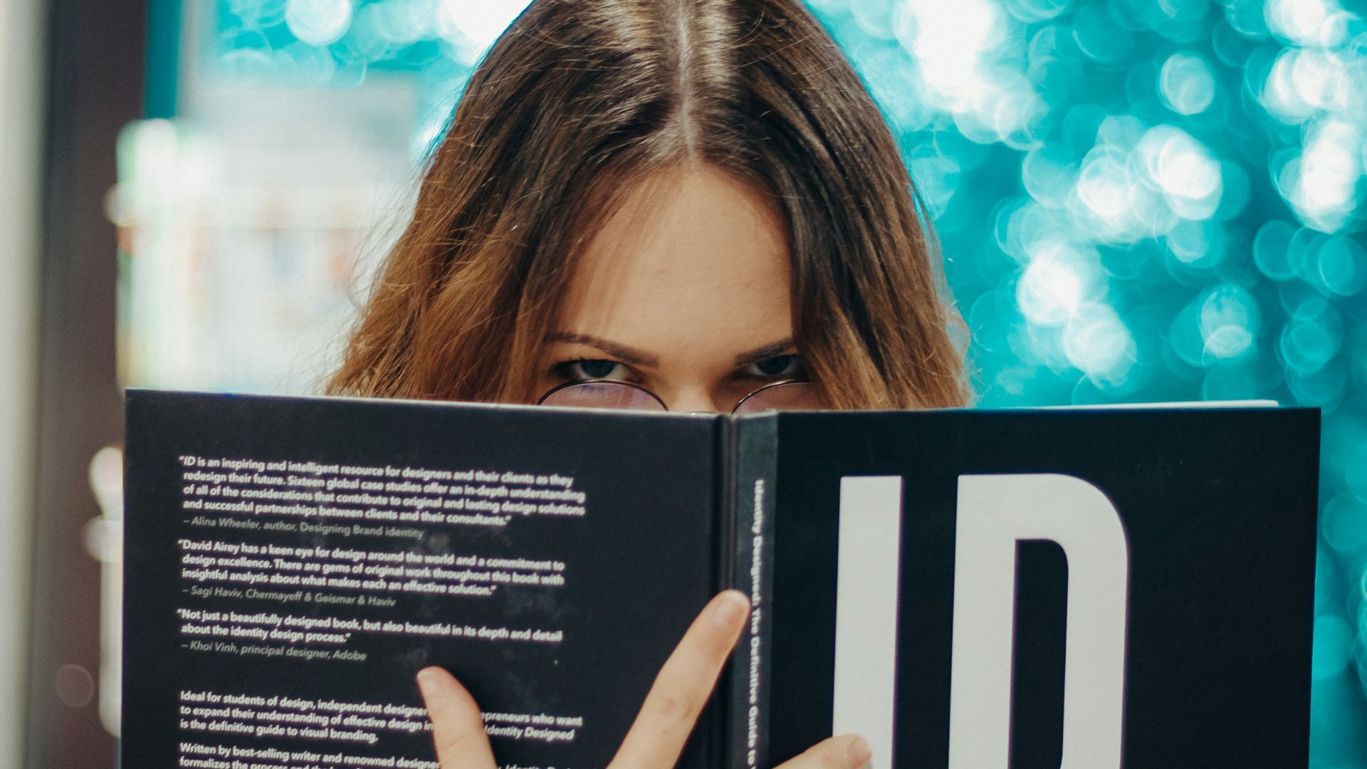 woman holding opened ID book