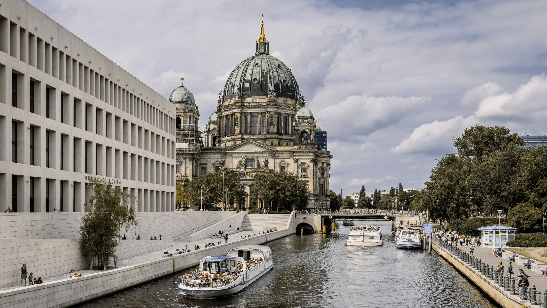 a river running through a city next to a tall building