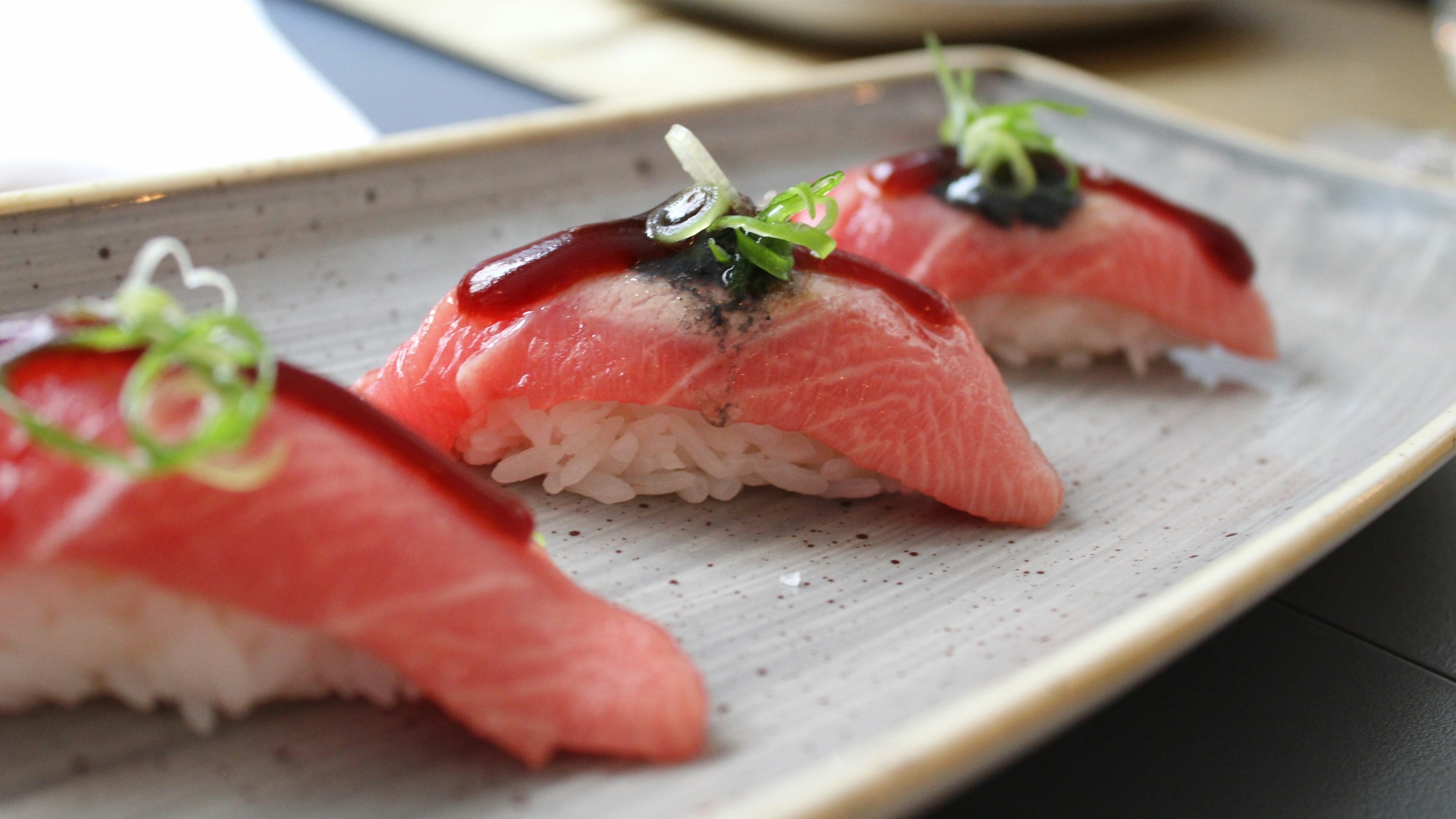 rice wrapped with fresh fish with garnish on top