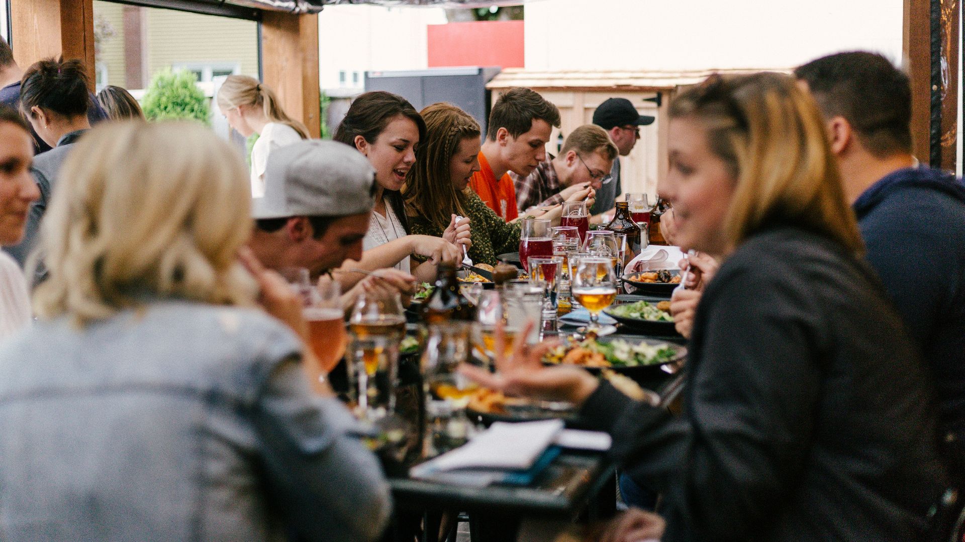 people sitting in front of table talking and eating