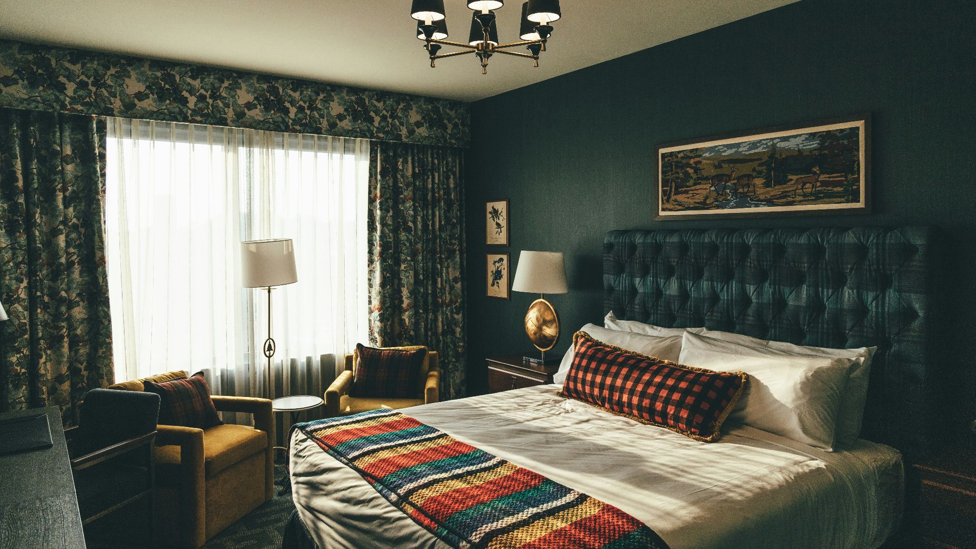 black and white uplight chandelier turned on near brown sofa