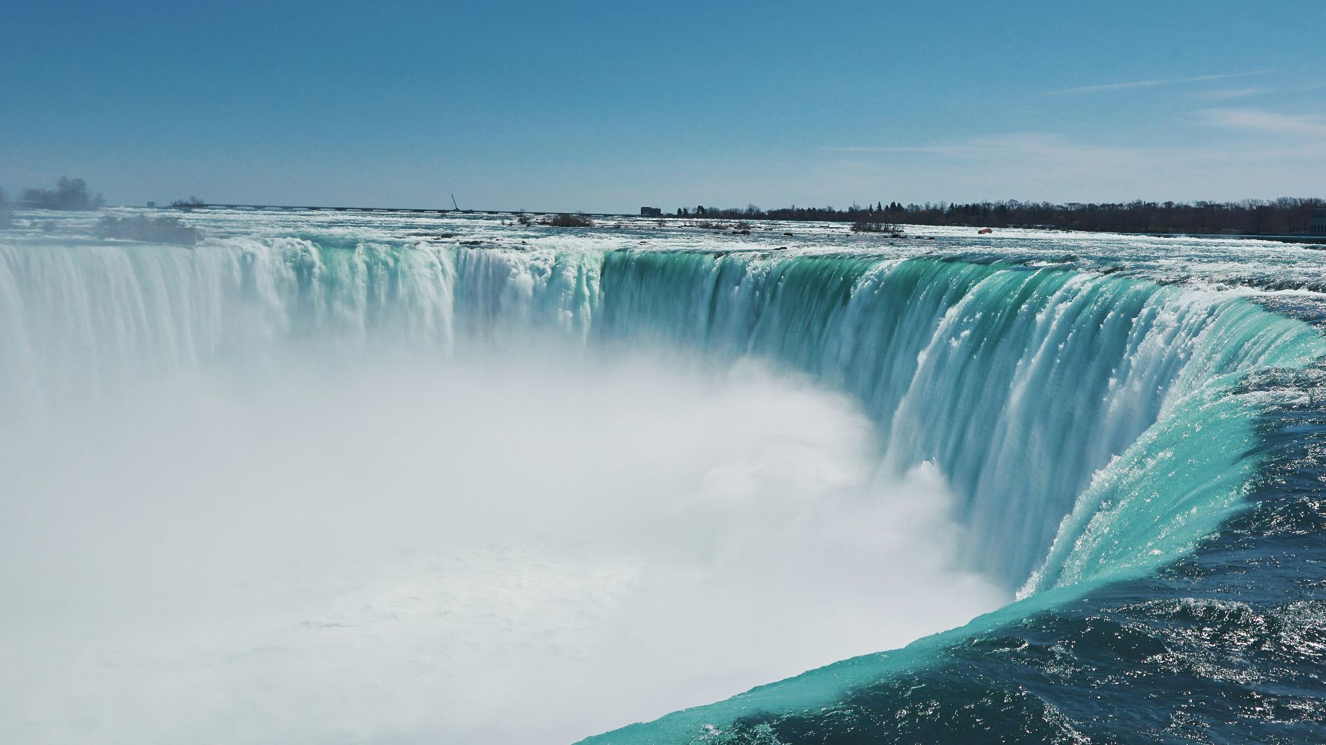 A large waterfall with water pouring out of it