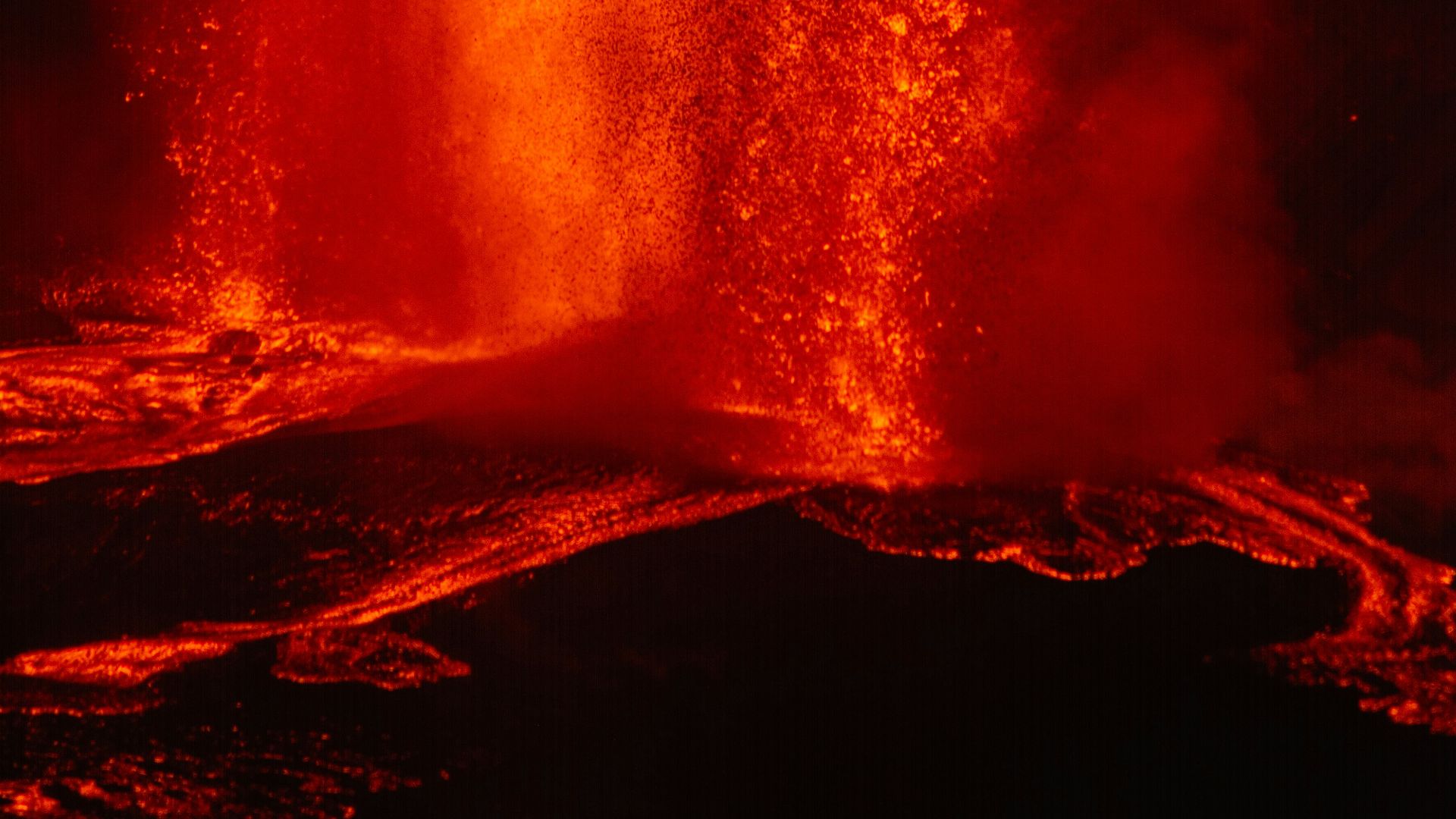 Volcano erupting with molten lava and smoke