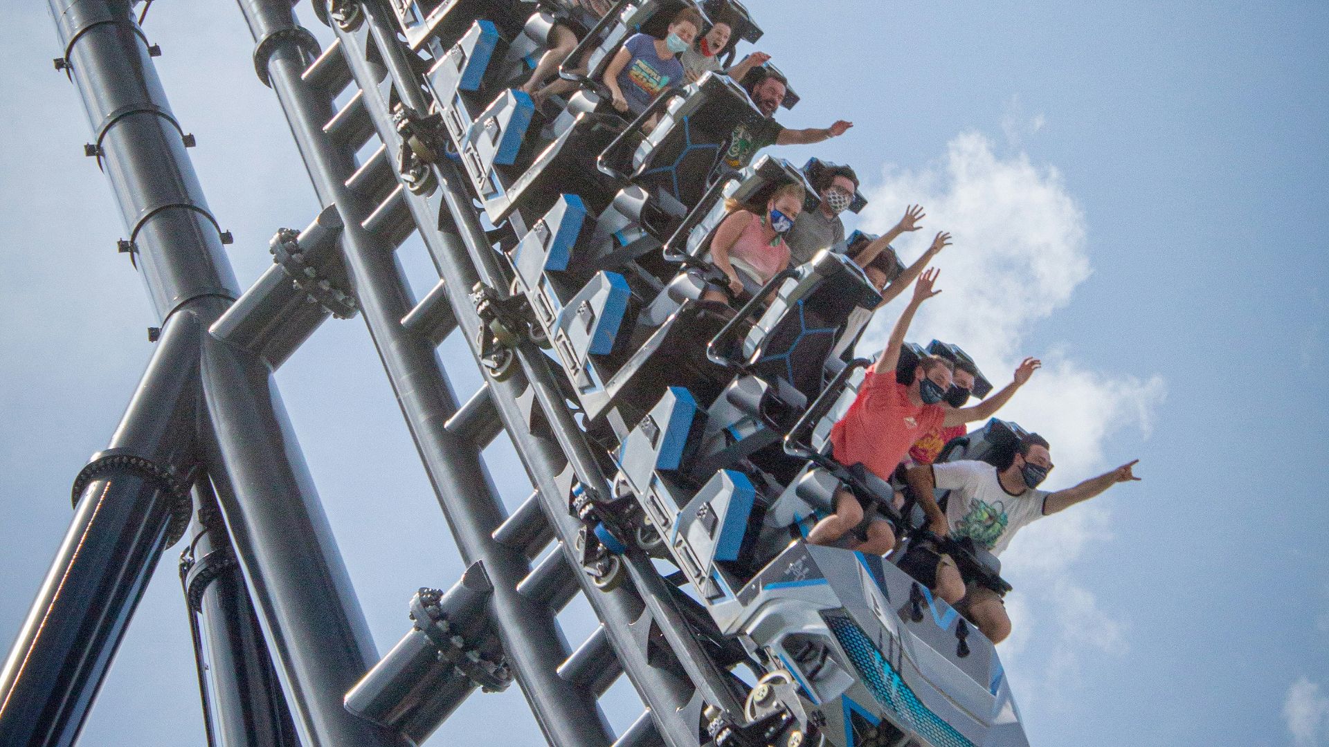 people riding on roller coaster during daytime