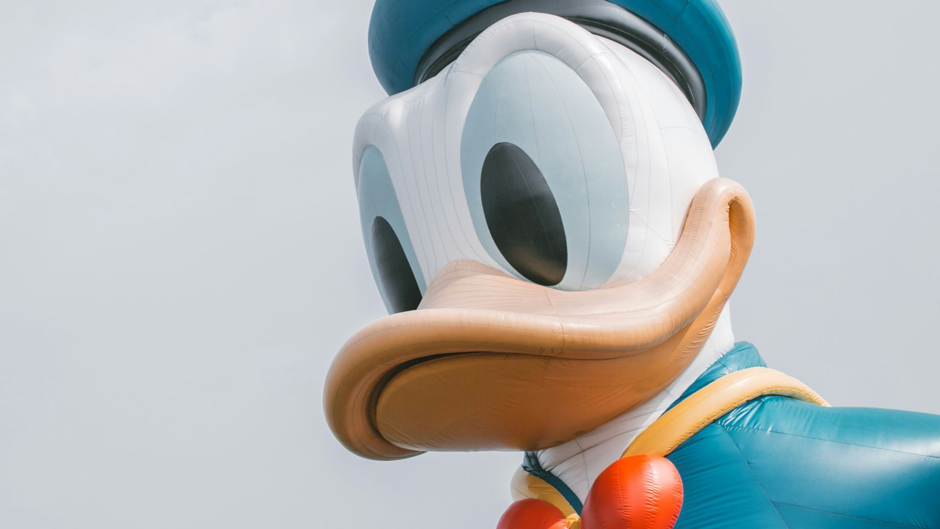 a large mickey mouse balloon with a bow tie