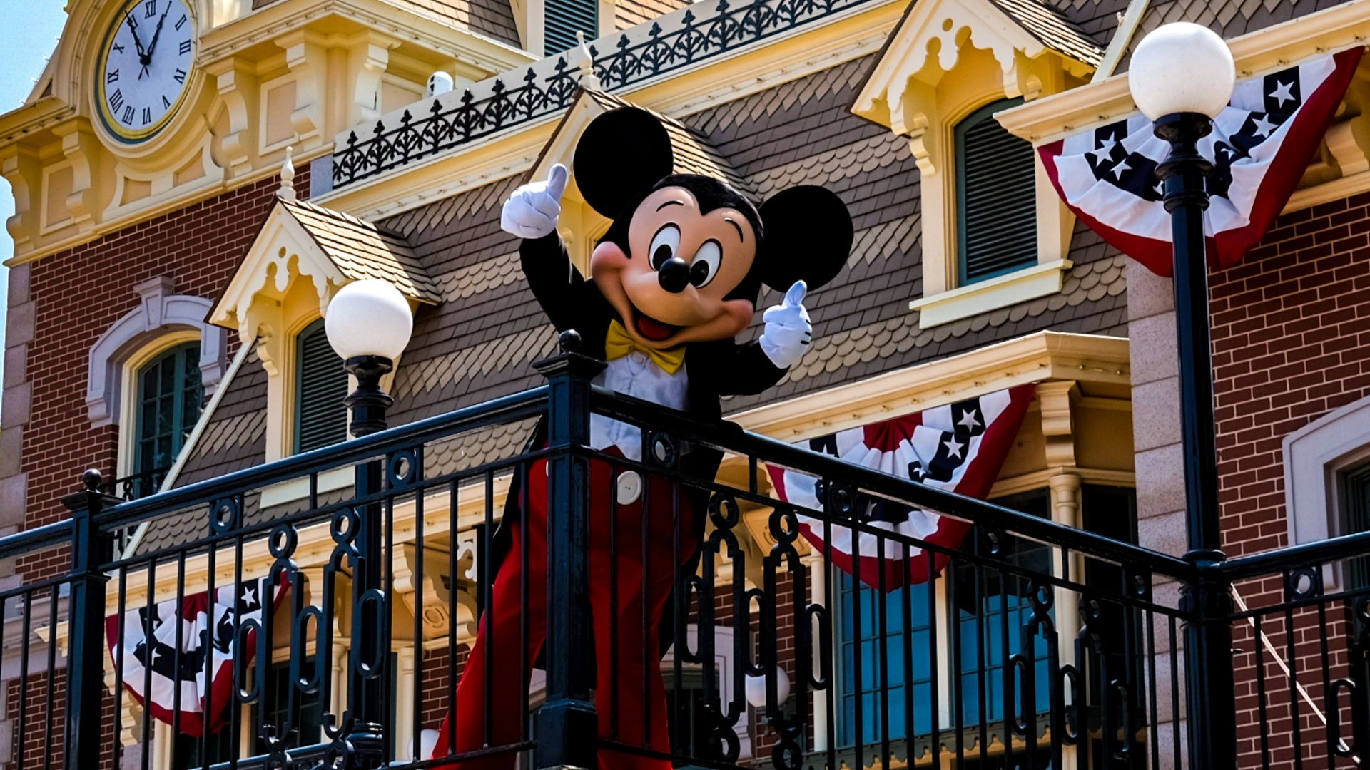 a mickey mouse statue on top of a building