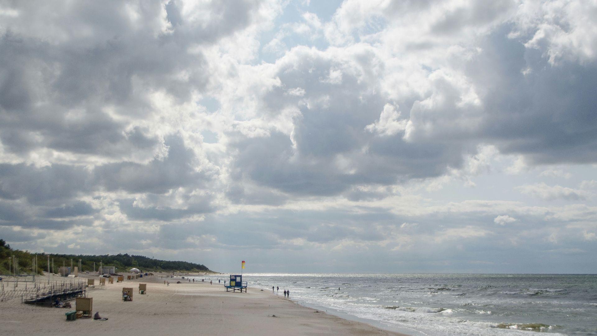 a beach with a pier and a body of water