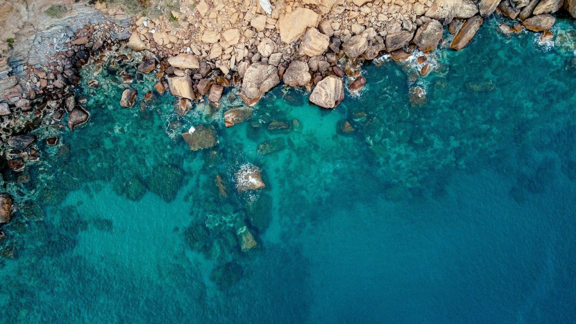 brown rocks on blue water