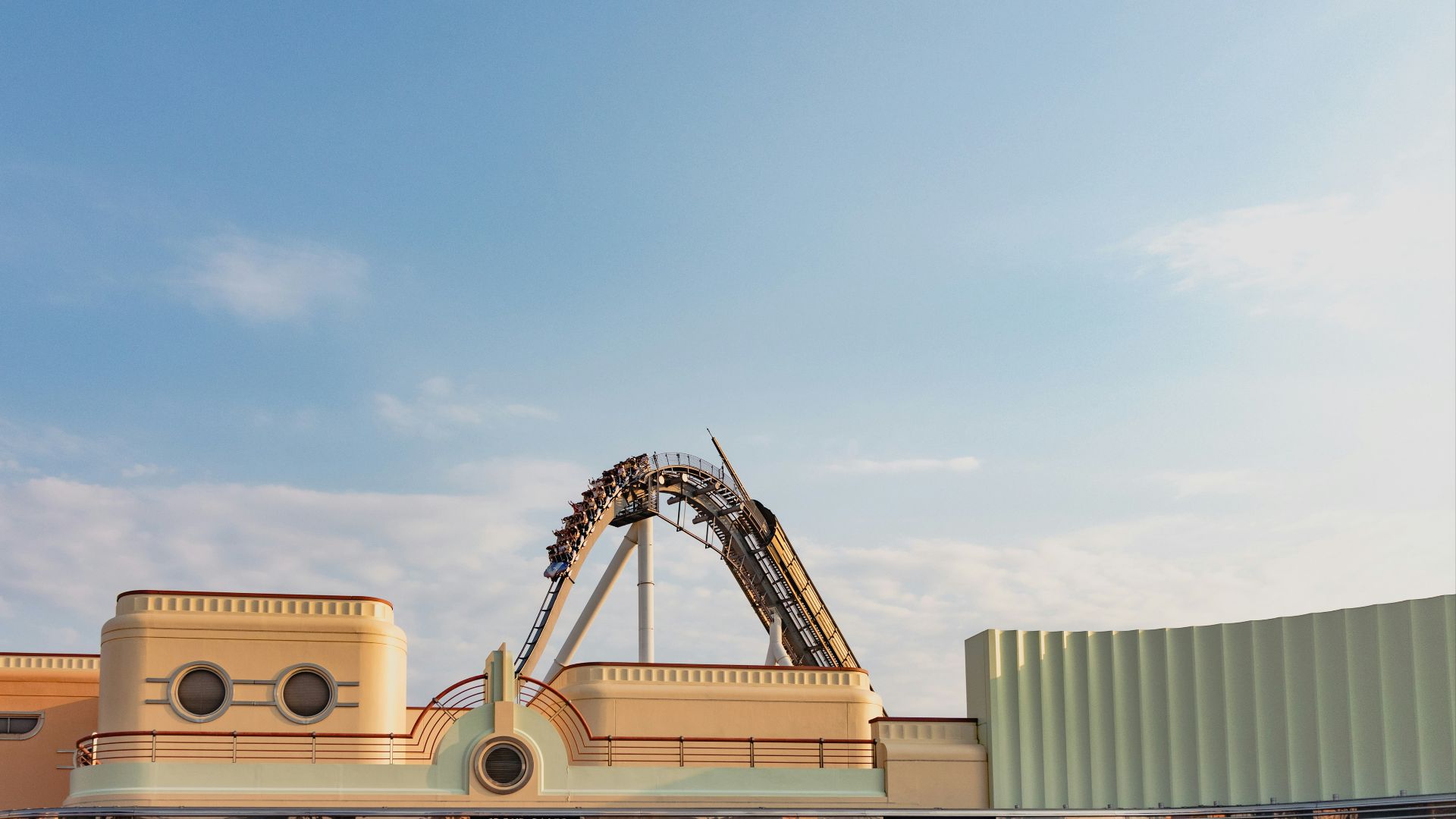 A roller coaster in front of a building
